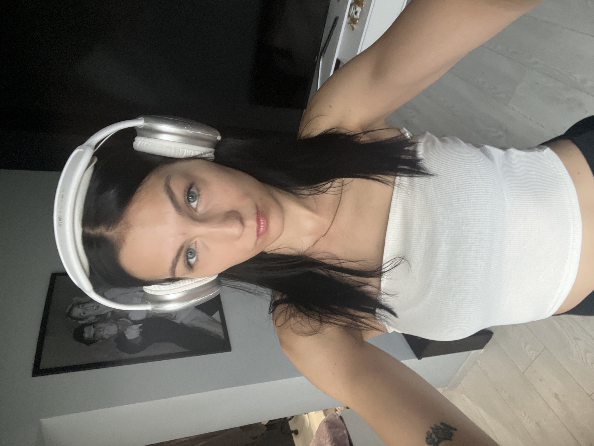 Woman takes selfies indoors, one rotated upside down