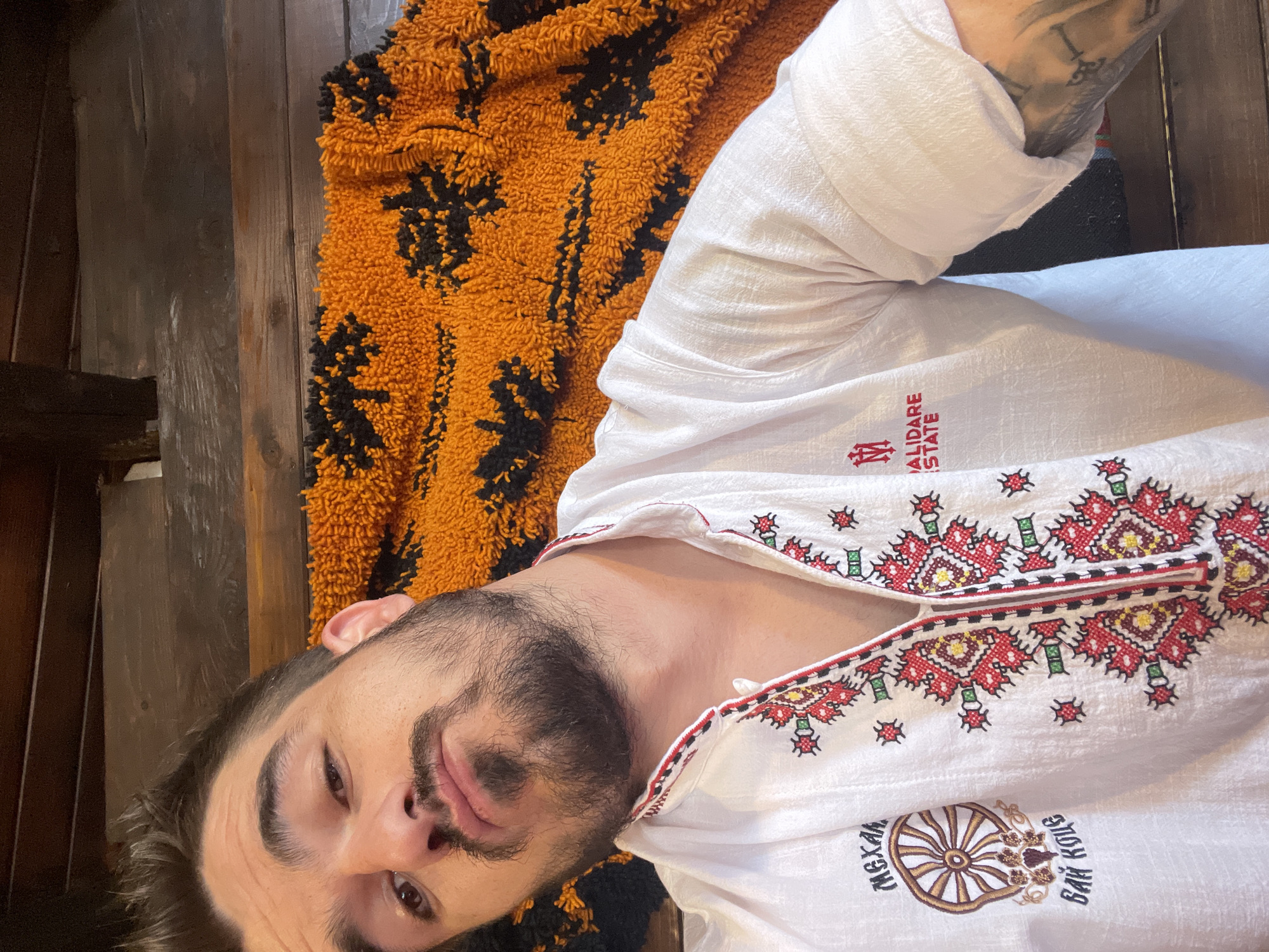 Man Takes Multiple Selfies at Outdoor Restaurant During Morning Hours