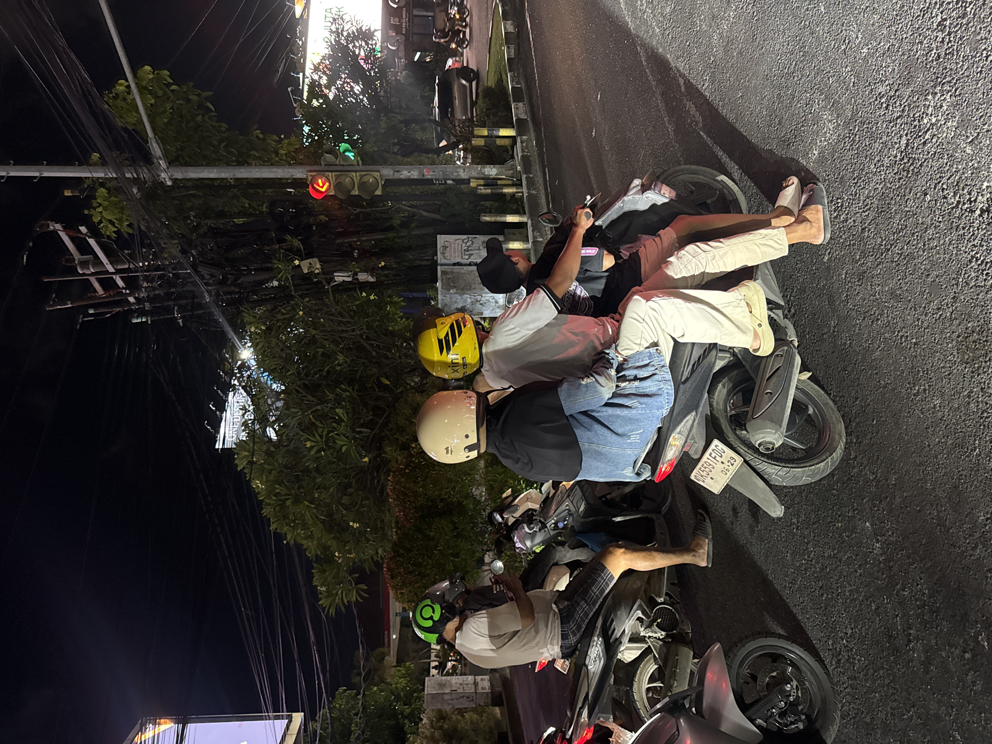 Kuta intersection at night, rain-slicked streets and traffic lights