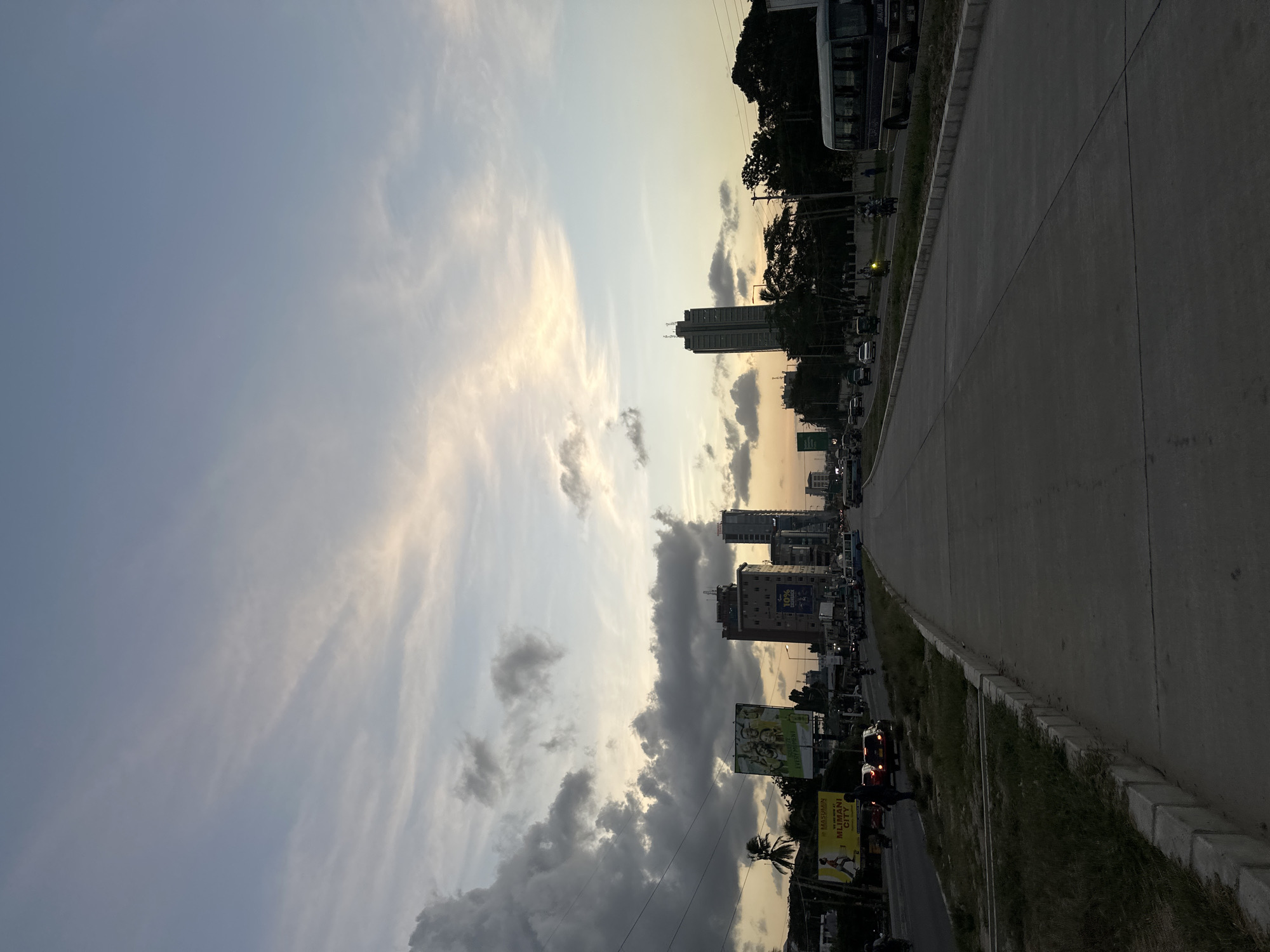 Dar es Salaam streets at dusk under a dramatic cloudy sky