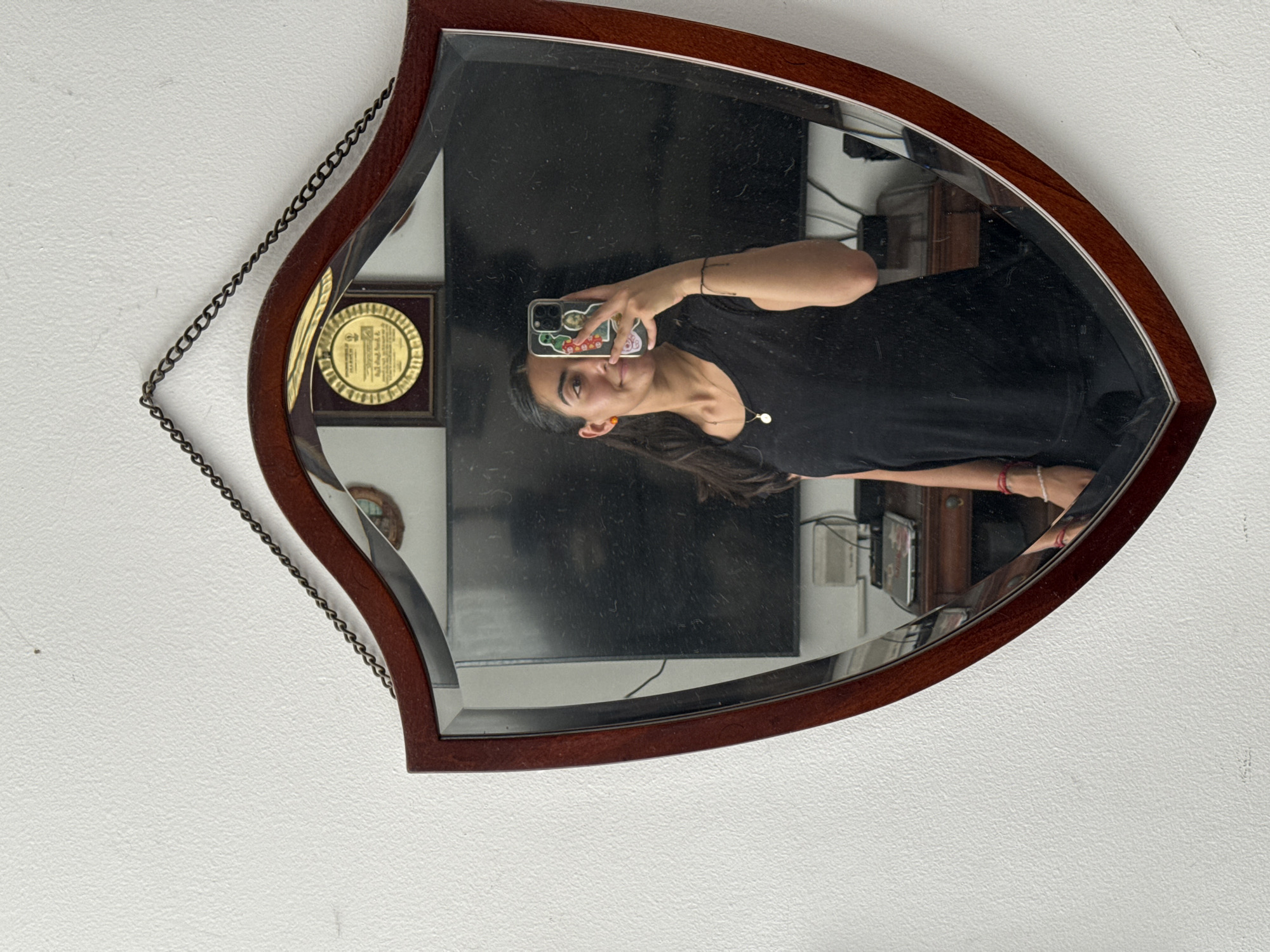 Person takes smartphone selfie in ornate mirror in Puebla
