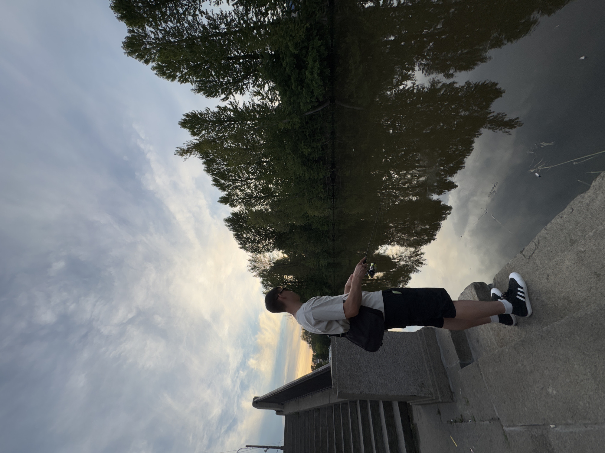 Fishing at dusk on a Saint Petersburg canal, golden dome in view