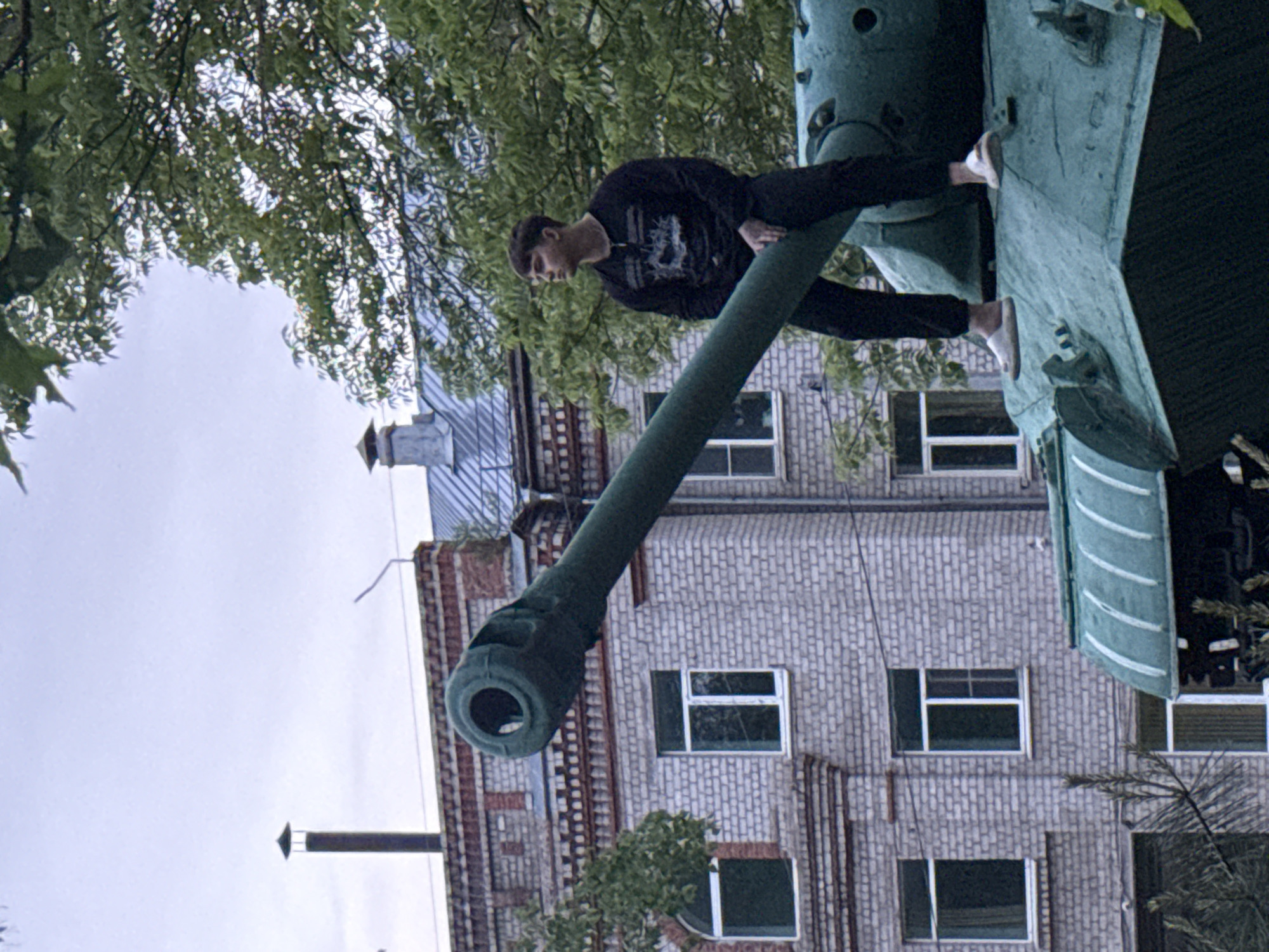 Young person poses on Soviet tank monument in Birobidzhan park
