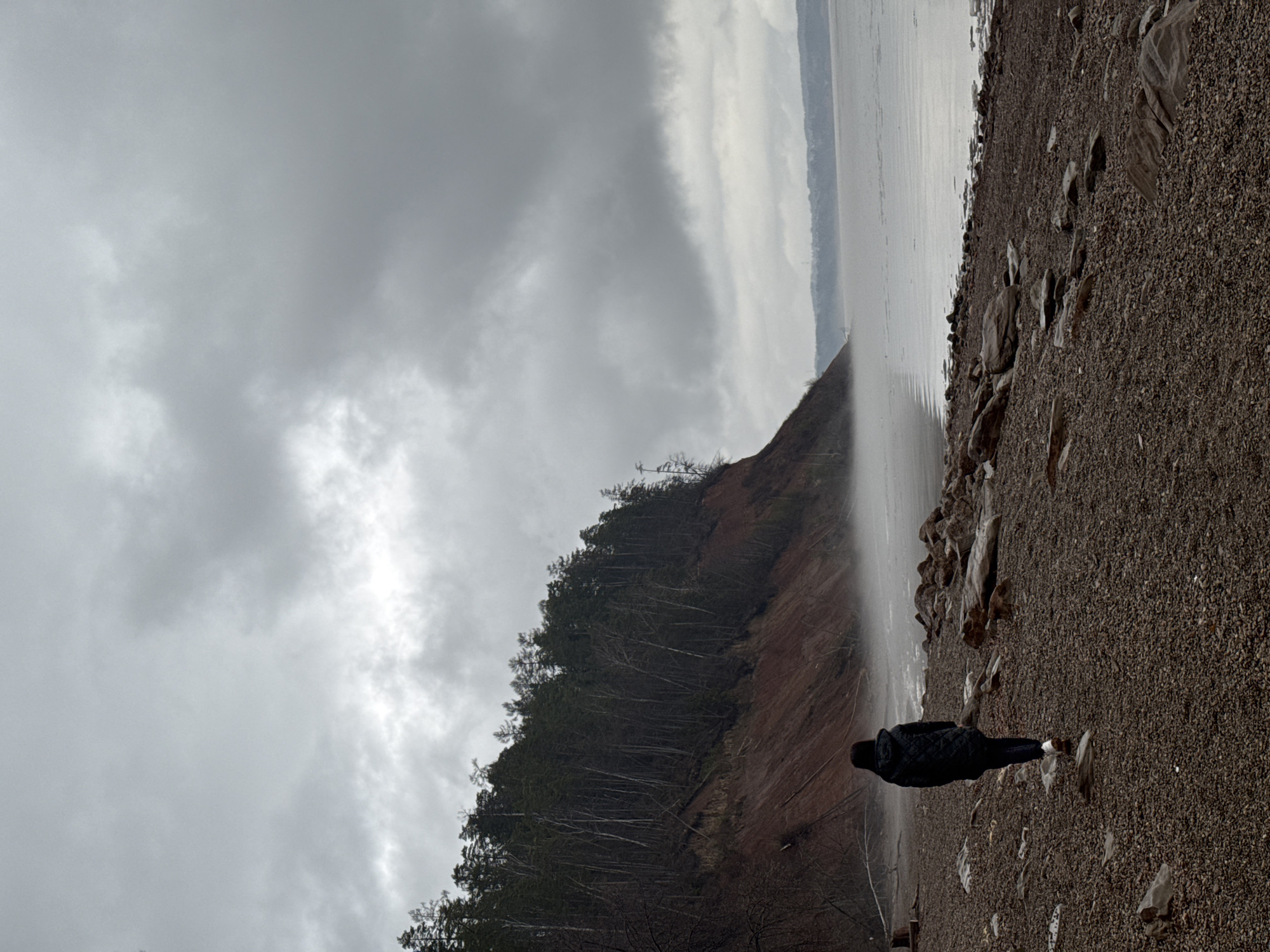 Solitary figure observed on Russian beach during cloudy afternoon