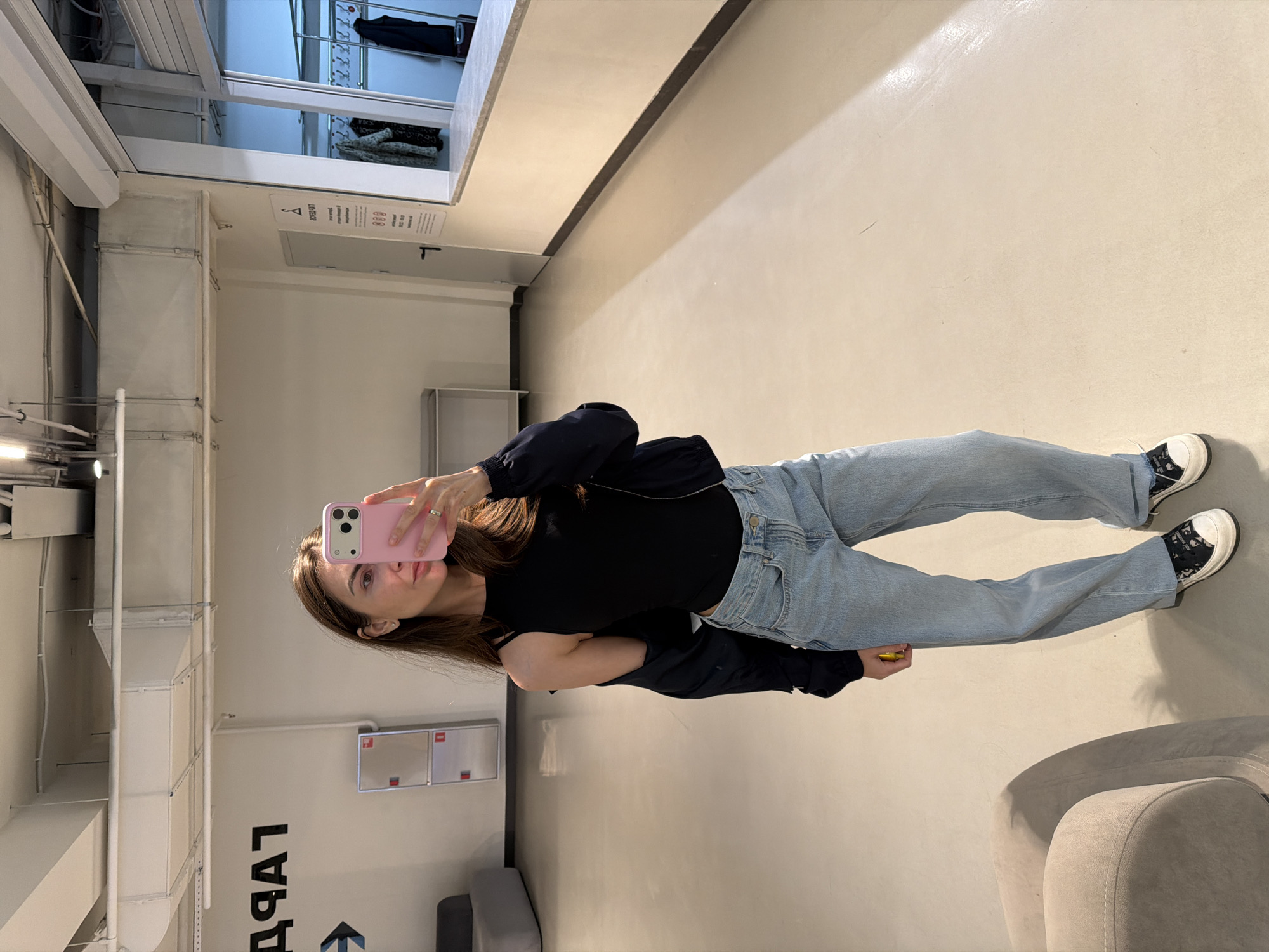 Woman takes selfie in retail space in Krasnoyarsk