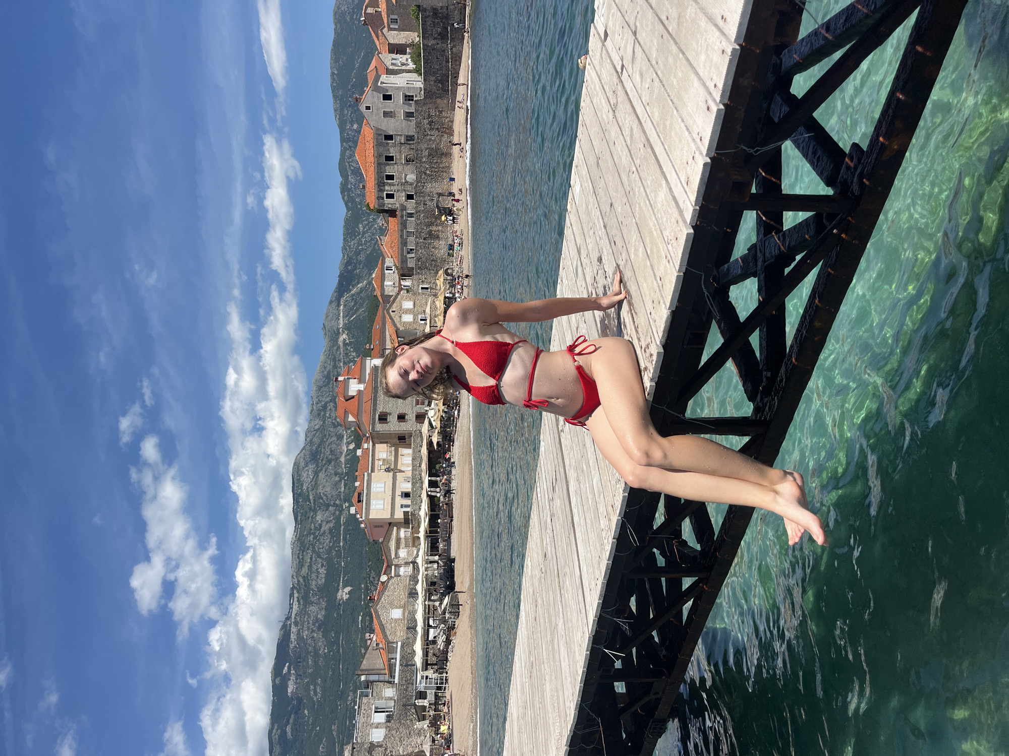 Tourist enjoys summer morning at Budva Montenegro waterfront