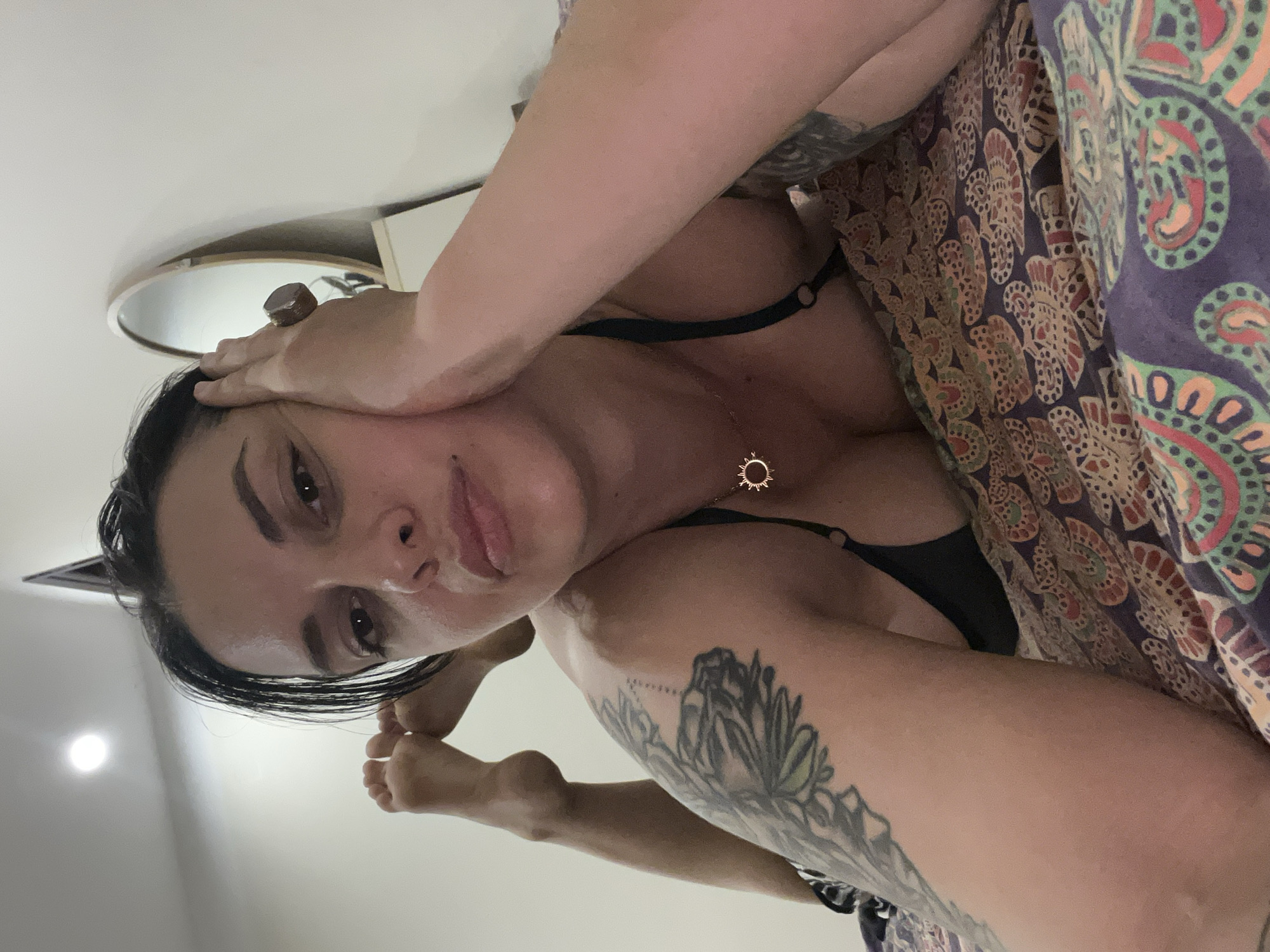 Bedroom selfie session in Đà Nẵng with sun pendant necklace