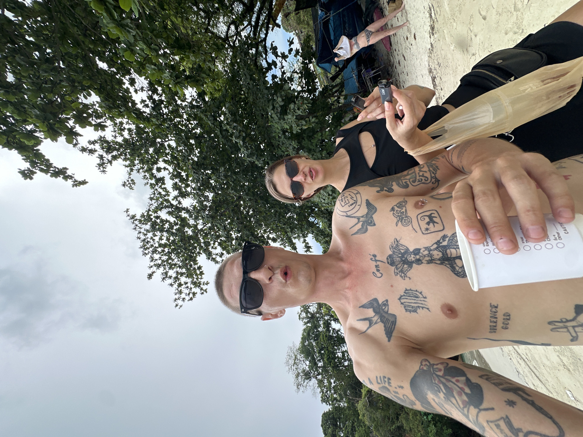 Selfie on Karon Beach, tattoos and shoreline in frame