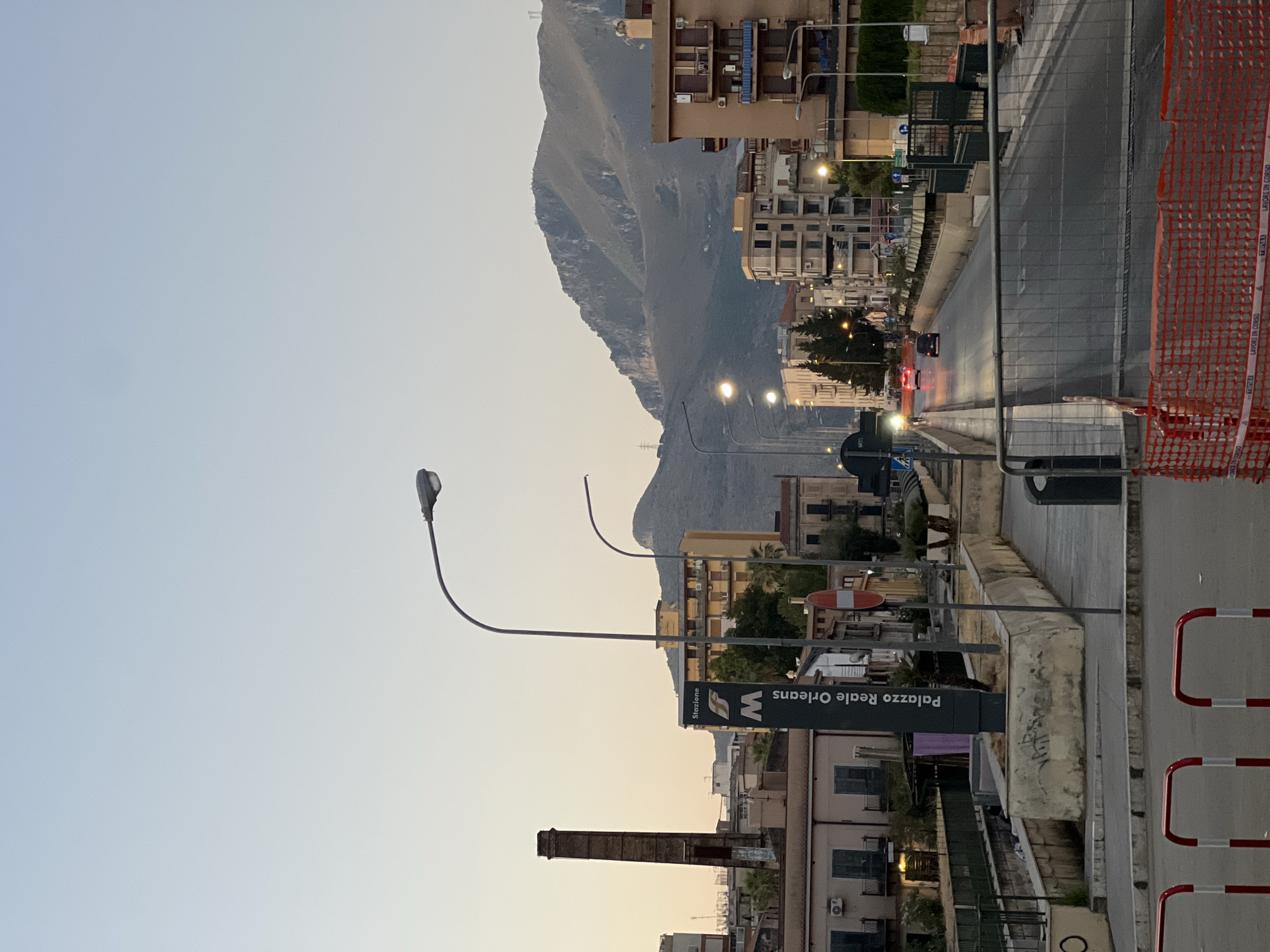 Palermo streets at dusk, quiet corners and mountain backdrop