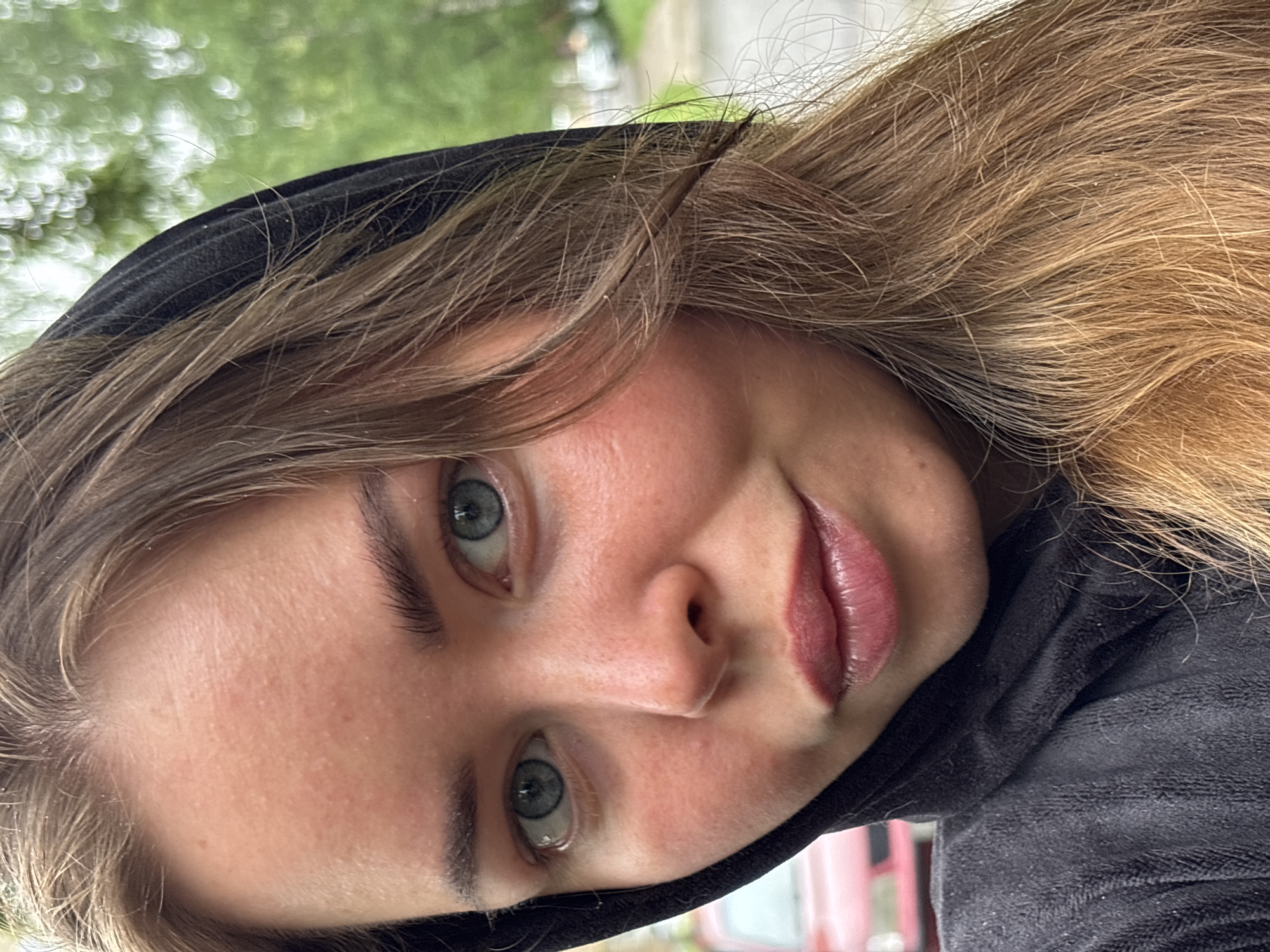 Woman takes selfie in black hoodie in Izhevsk
