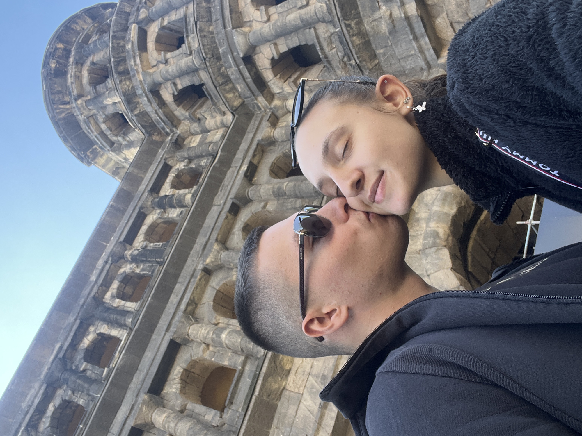Couple visits historic Porta Nigra gate in Trier, Germany