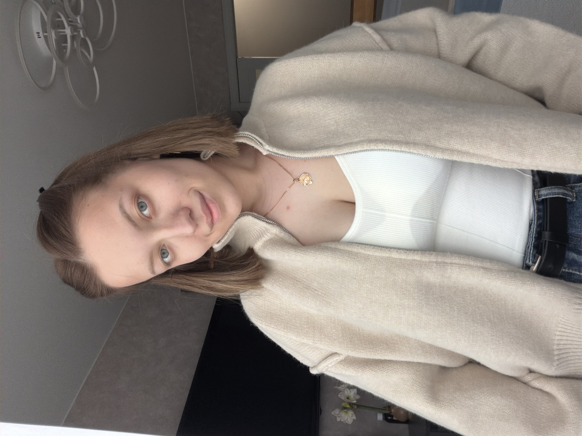 Young woman poses for indoor portraits in Reshetnikovo