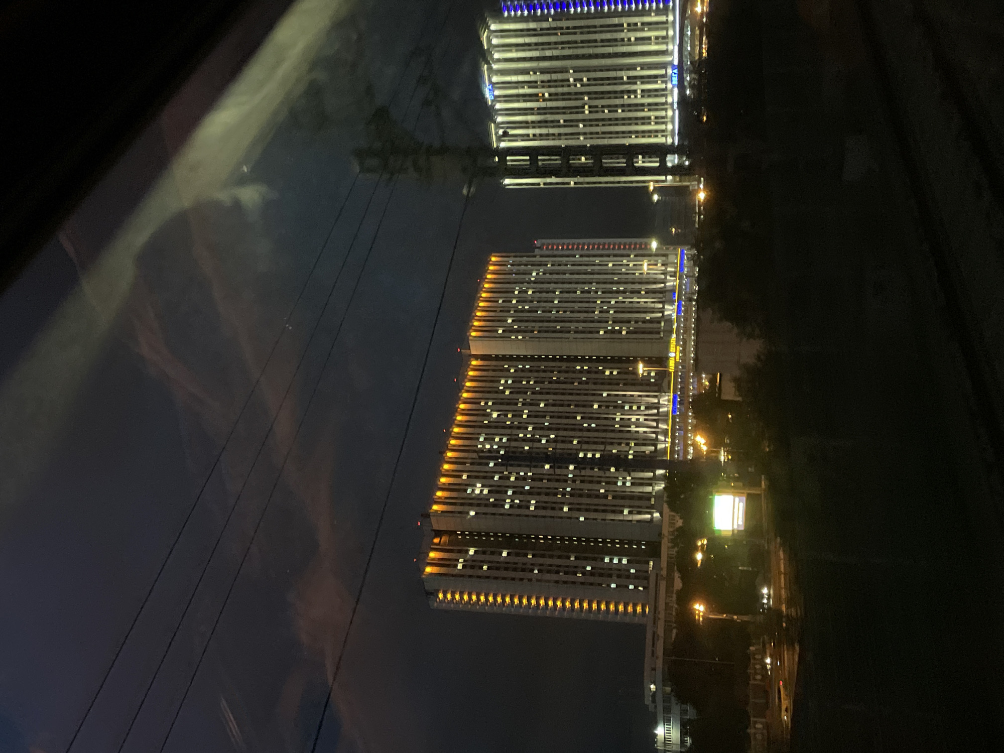 Moscow City skyline rolling past through a vehicle window at night