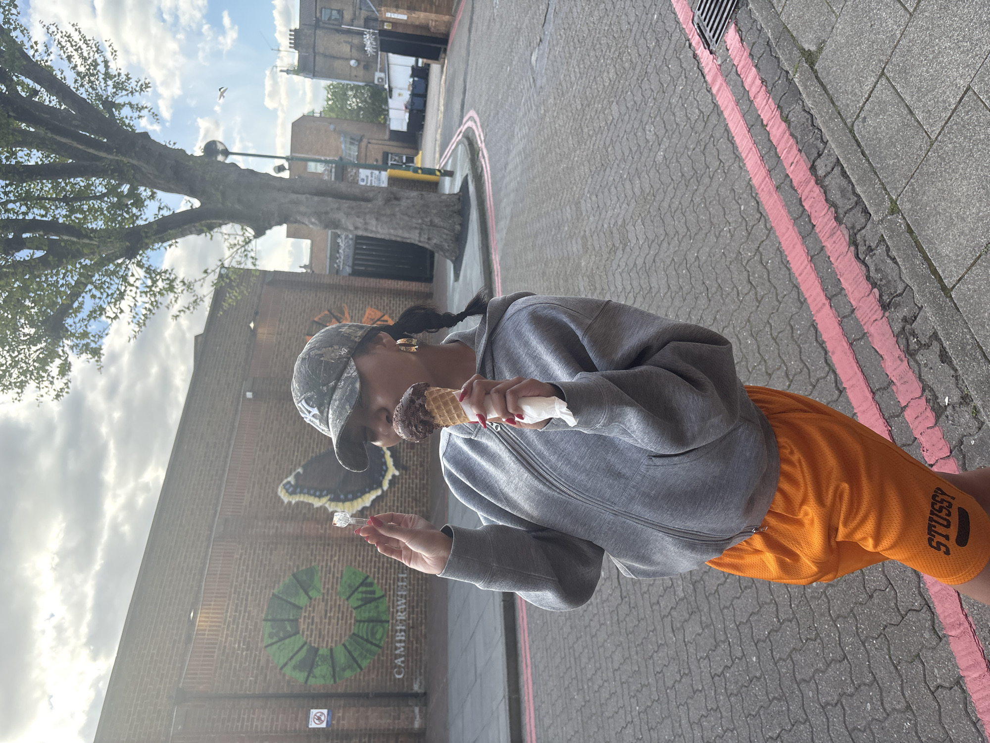 Woman enjoys ice cream on Camberwell street Sunday afternoon