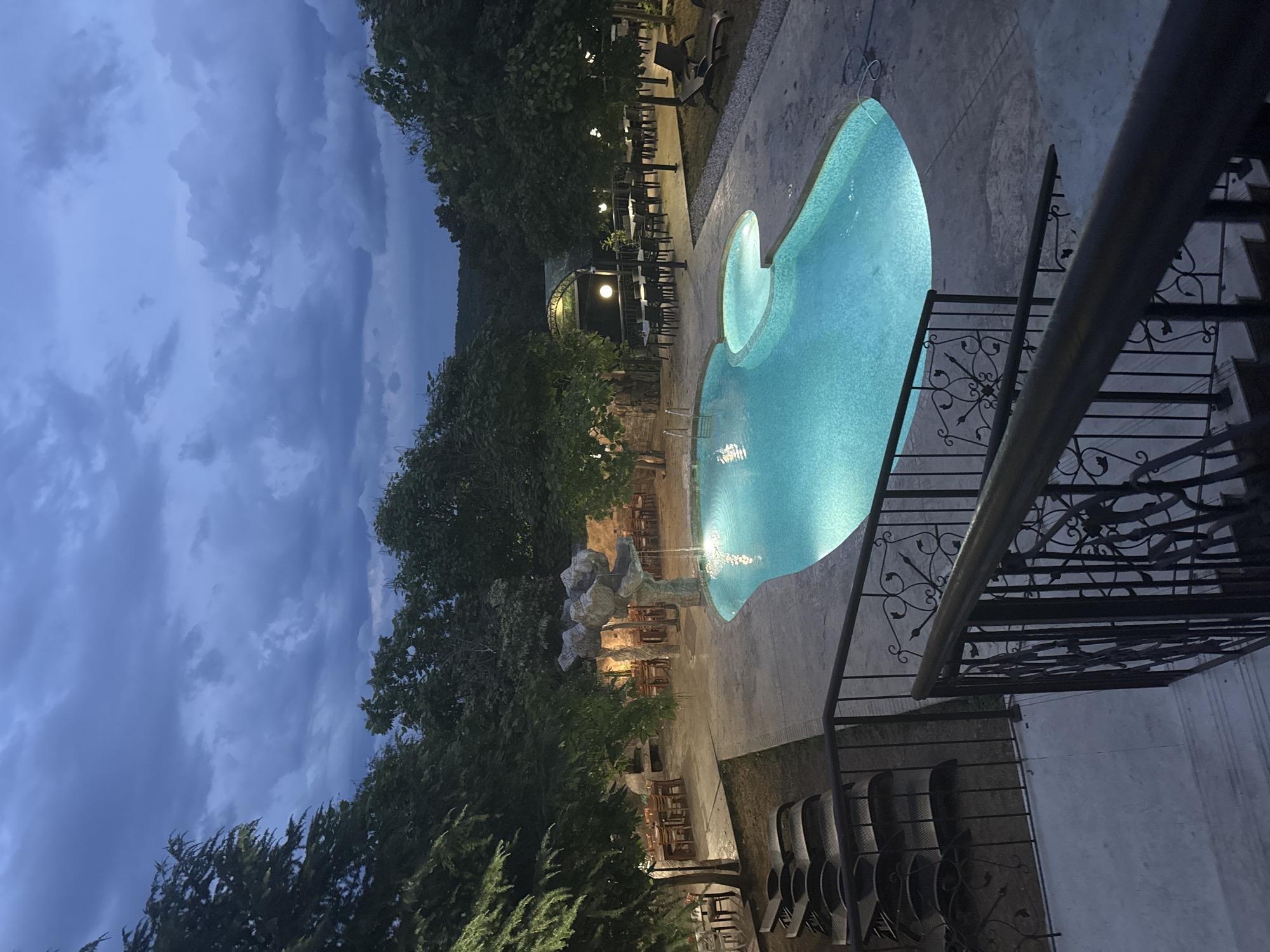 Poolside dusk at a Sredets resort, black cat on the steps