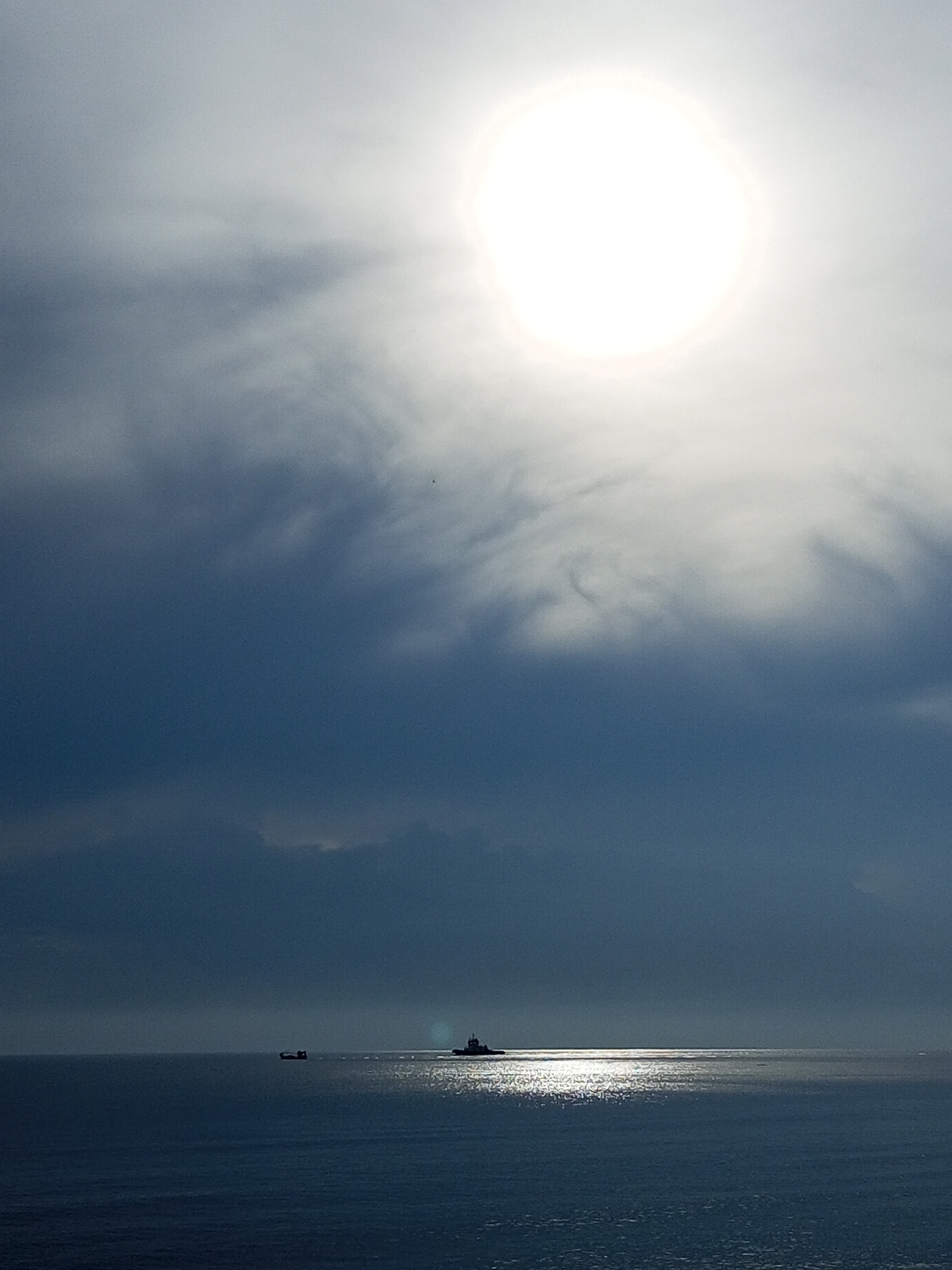Calm seascape with distant ships observed near Lhokseumawe coast