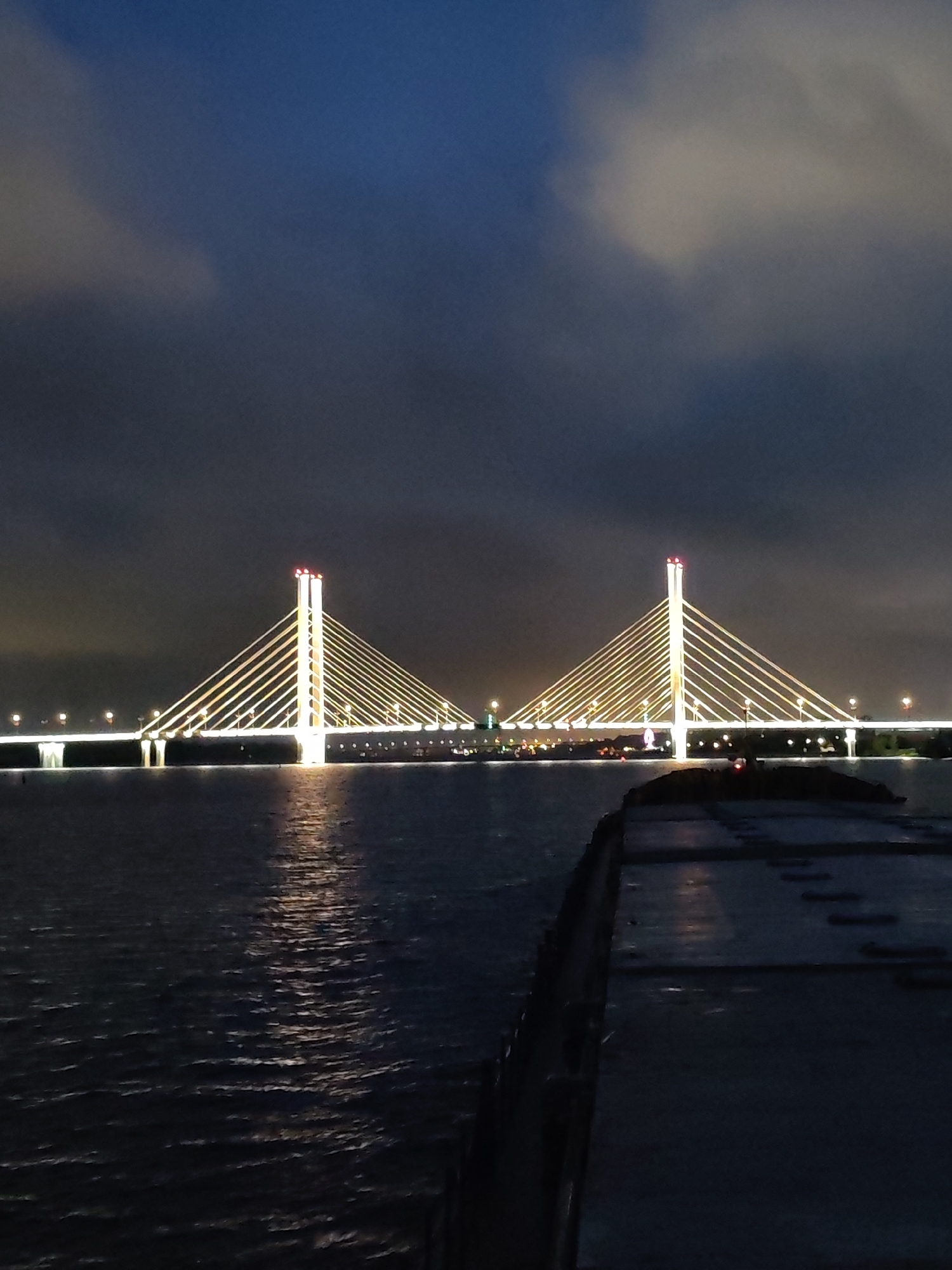 Cable-stayed bridge illuminated at night in Cherepovets, Russia