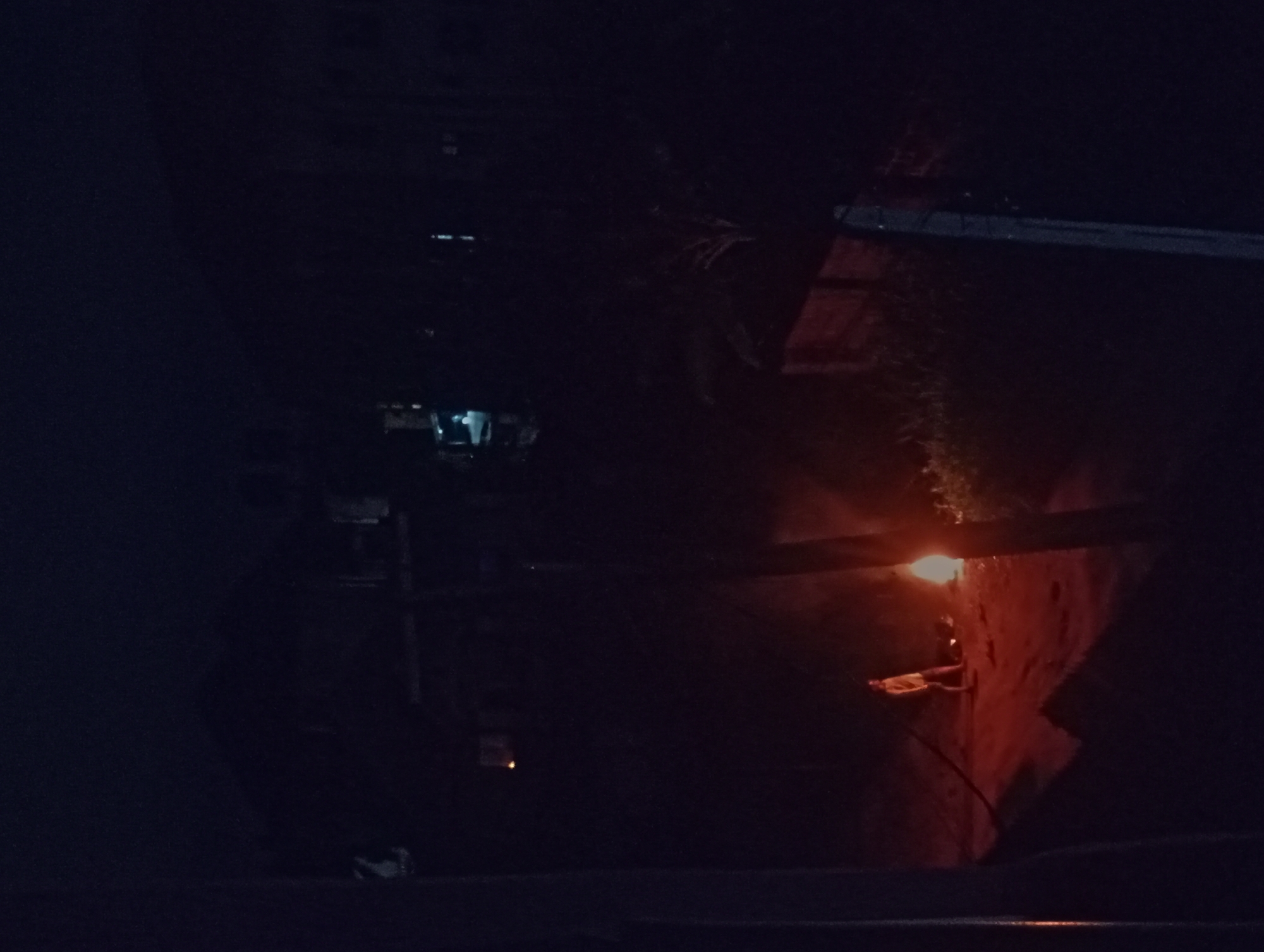 Nighttime alleyway captured in shadowy urban documentation