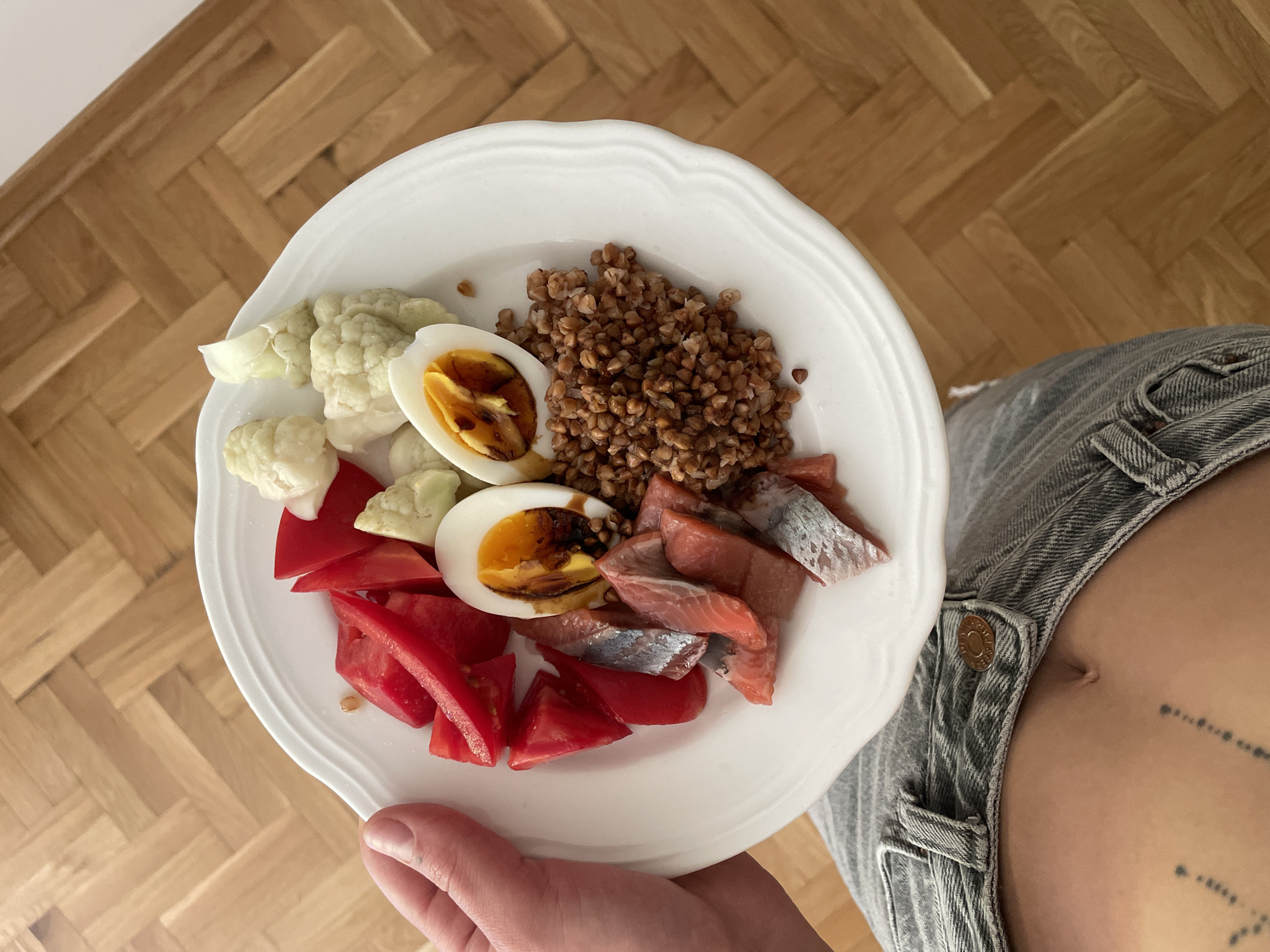 Person holds varied breakfast plate in Boreti, Montenegro