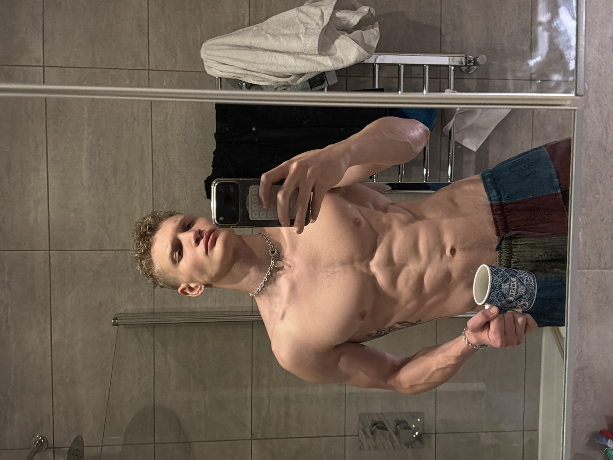 Man takes mirror selfie with cup in London