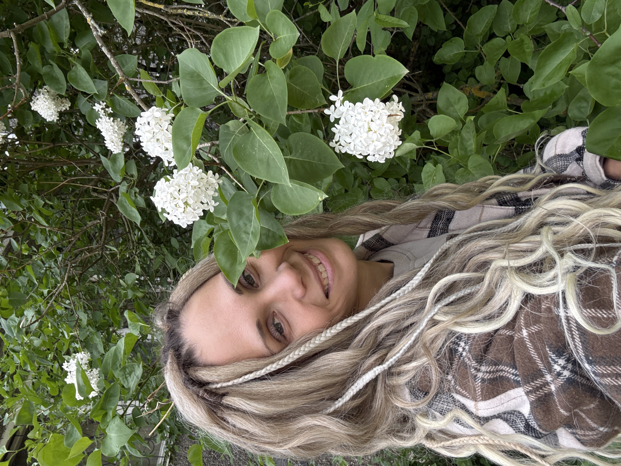 Woman poses for photos among spring flowers in Russian park