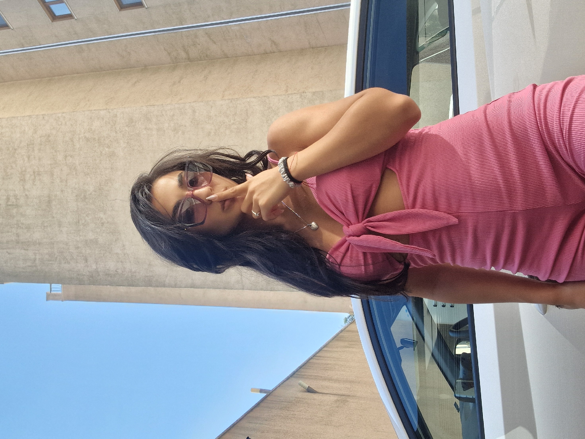 Pink outfit, white car, small dog — a casual day out