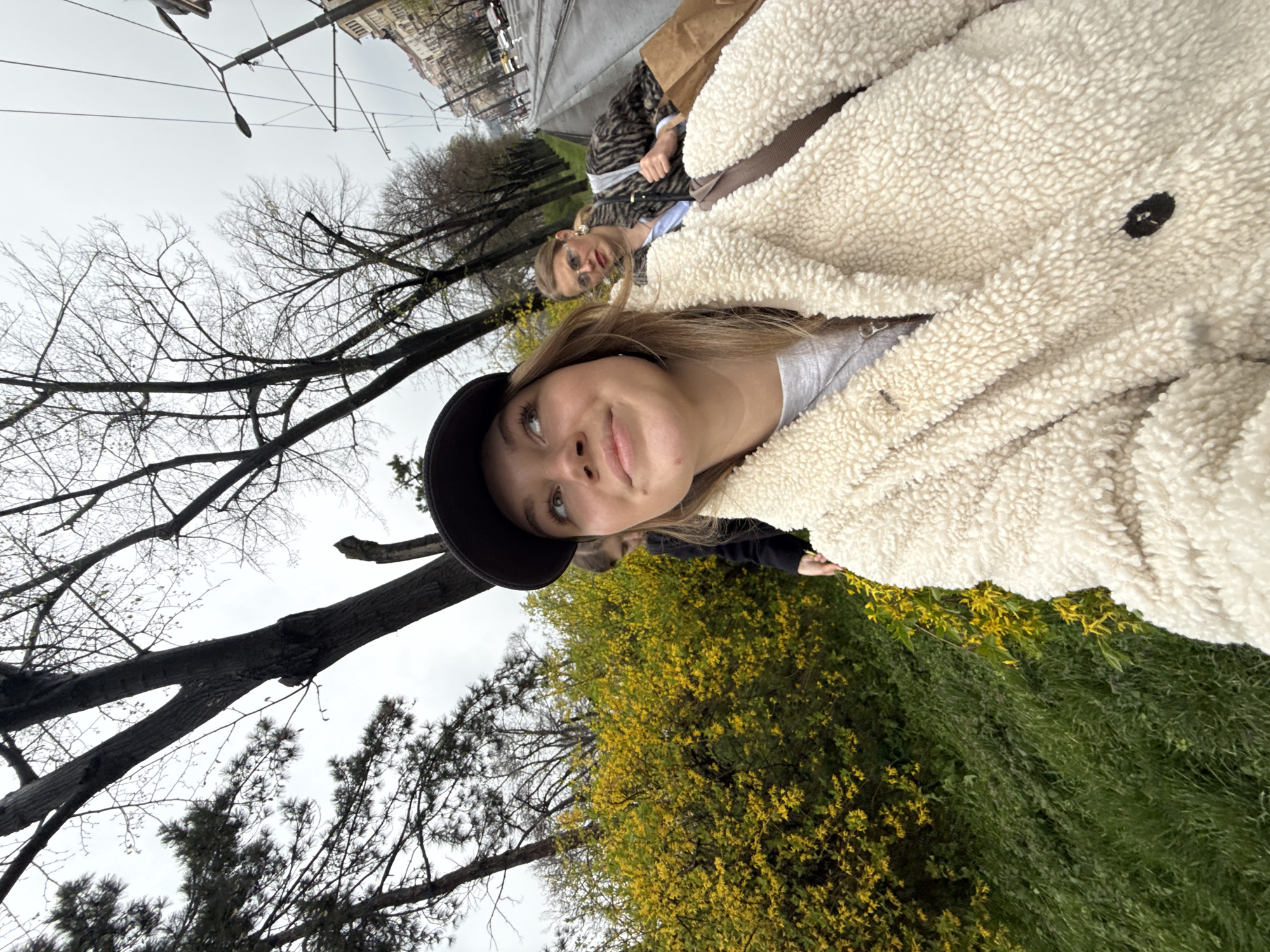 Woman takes selfies near spring flowers in Belgrade