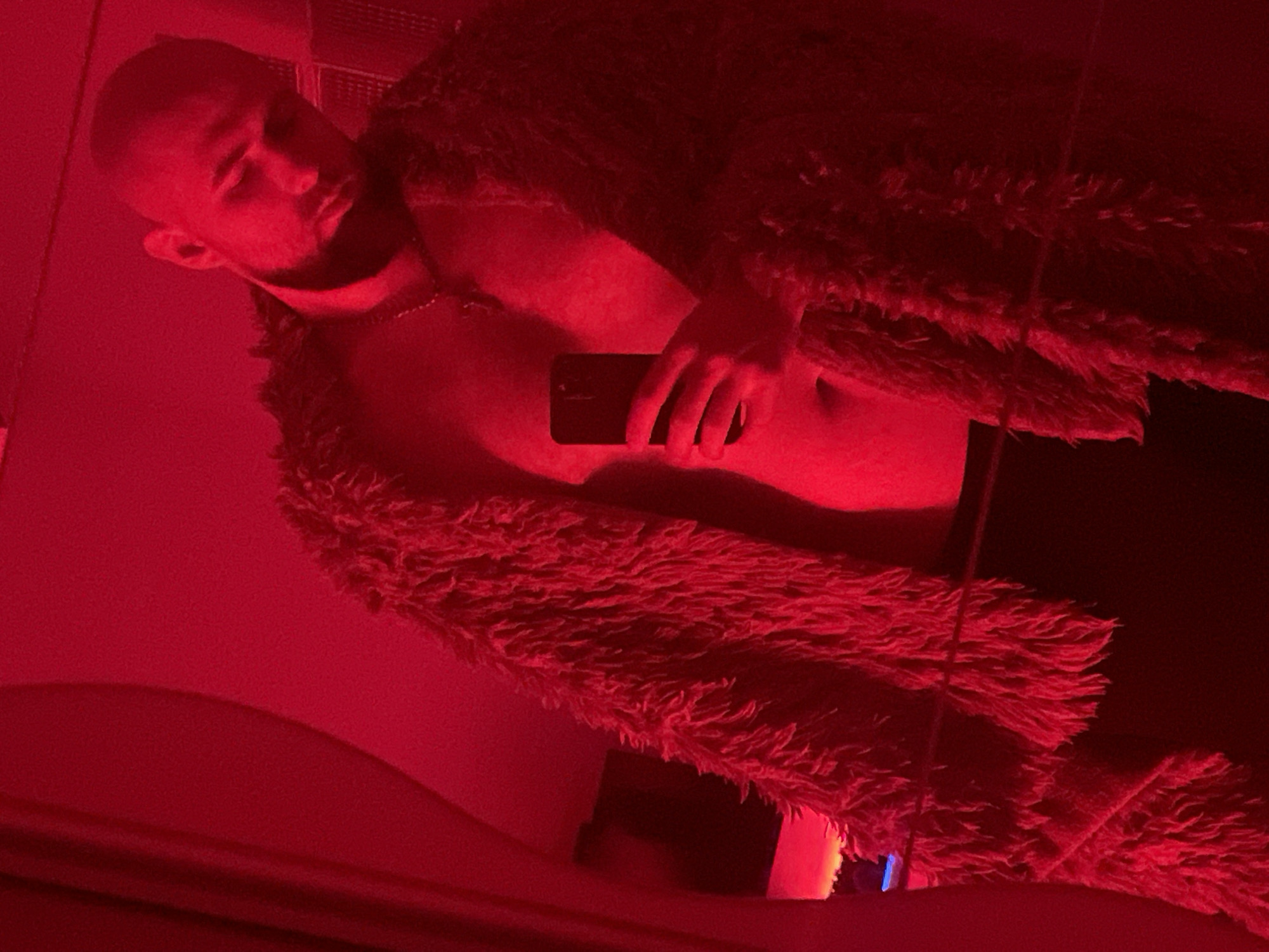 Red-lit selfie session in a Gliwice sim-racing room