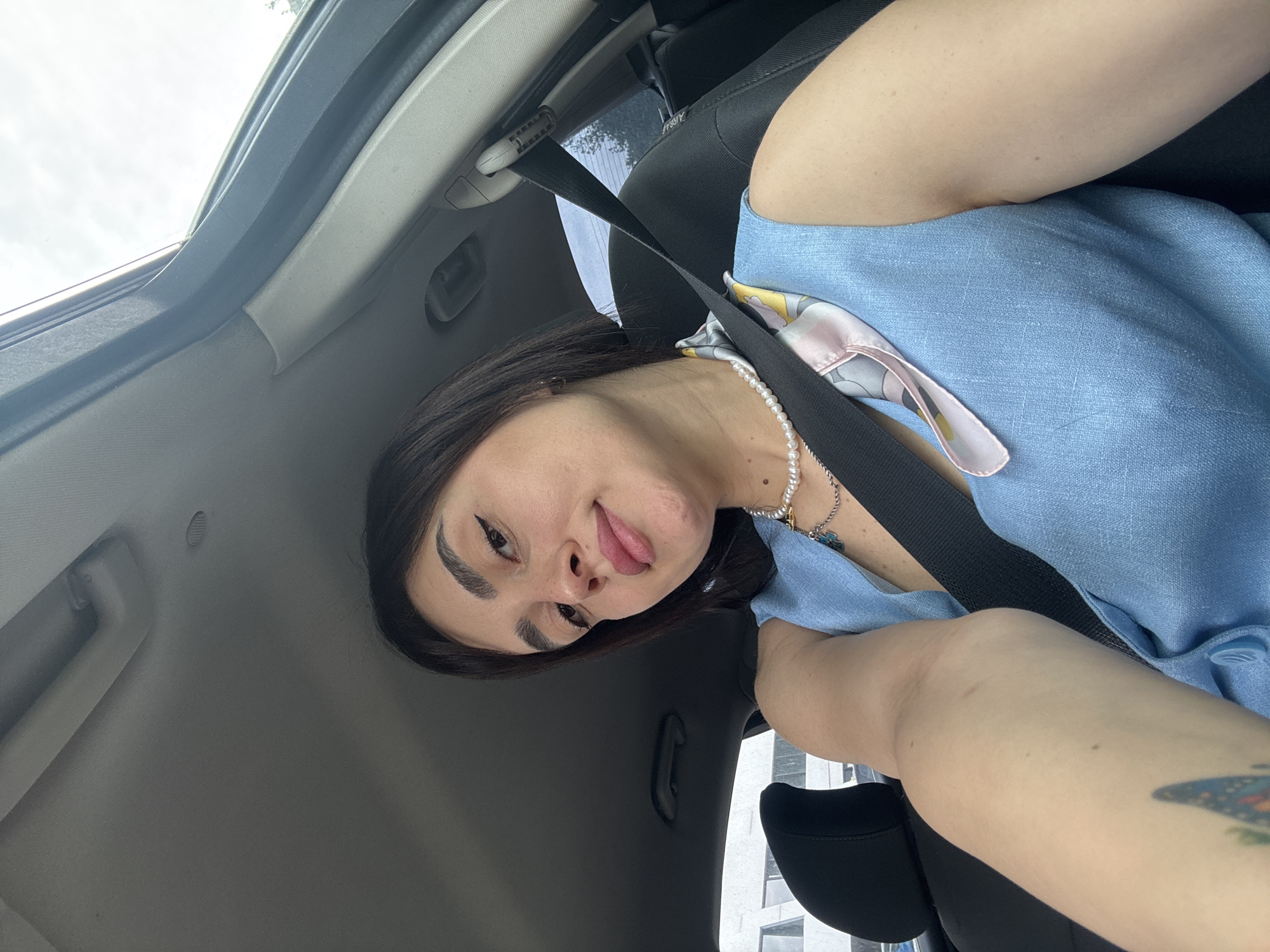 Woman photographed in car driver's seat in Tbilisi