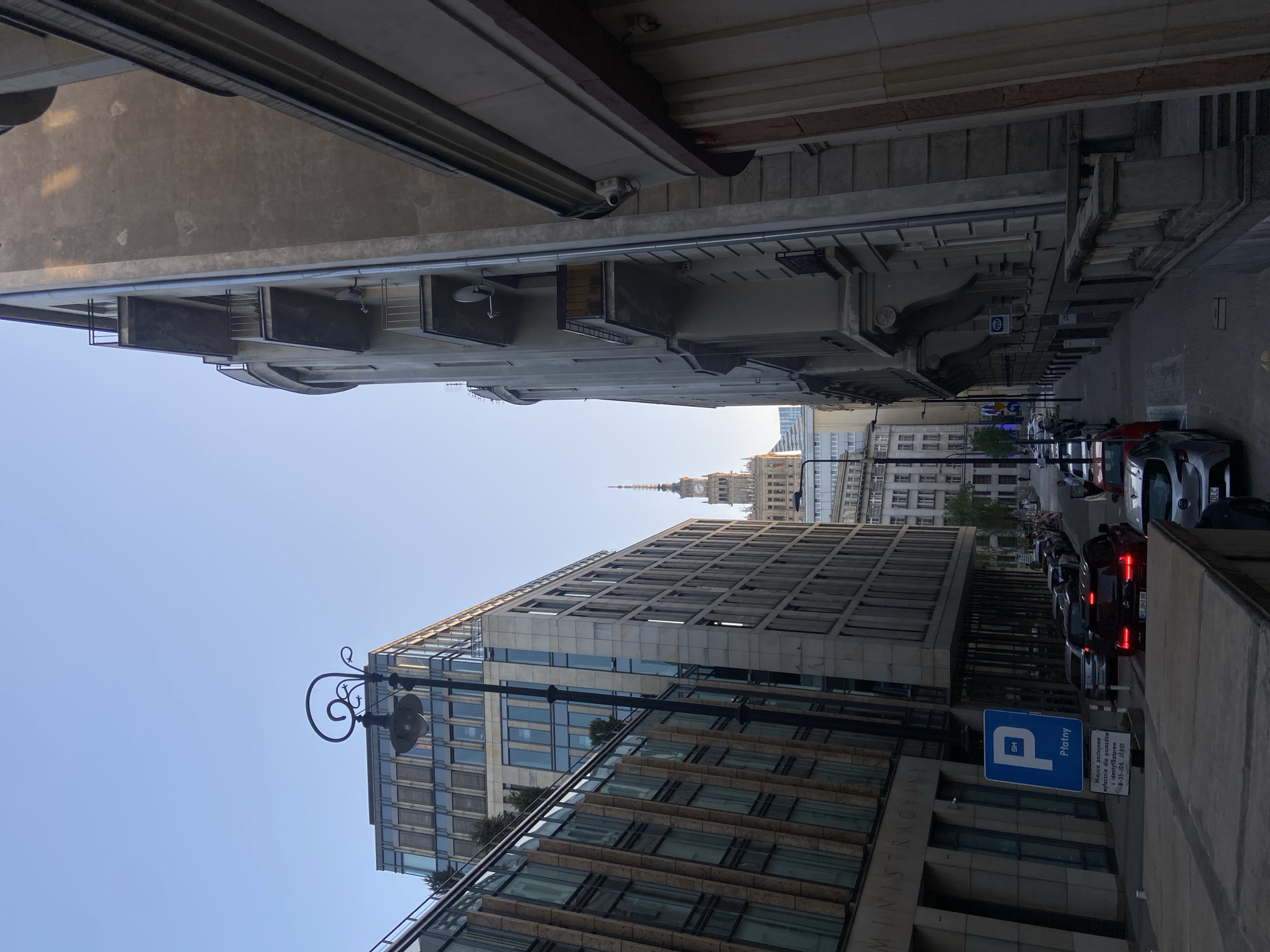 Central Warsaw streetscape, anchored by a café window view