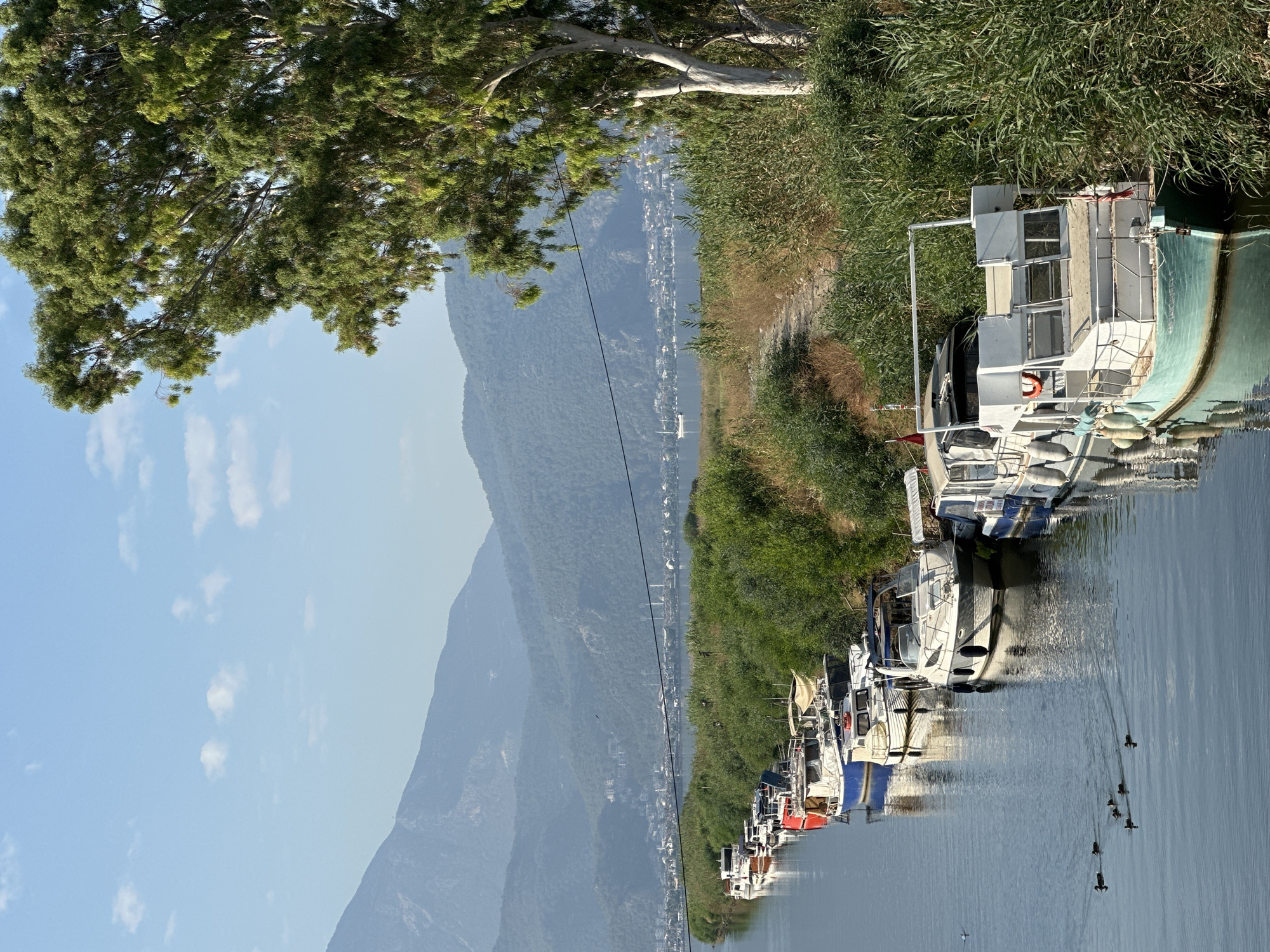 Boats moored along a calm canal in Fethiye, Turkey