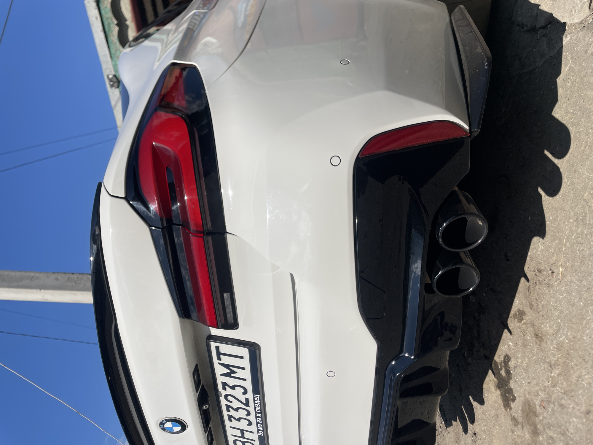 Midday stop in Ivanivka: street life, a BMW, and summer blooms