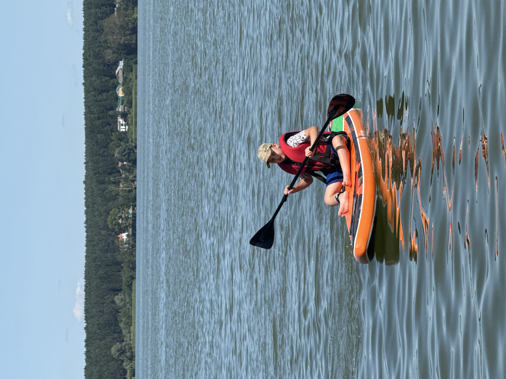 Paddleboarding and sailing on a Votkinsk lake on a summer morning