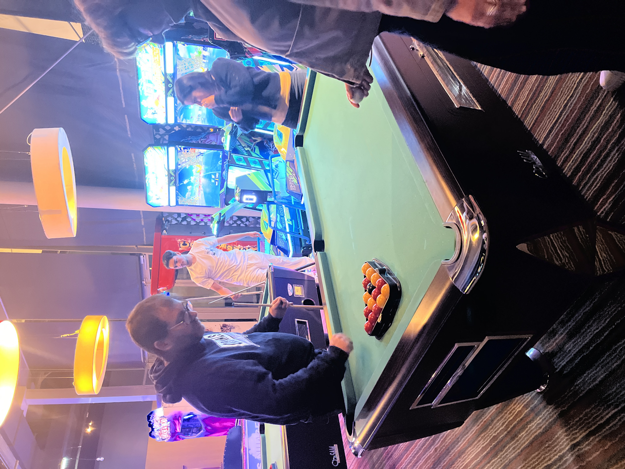 Evening arcade gaming session captured in Montrond-les-Bains entertainment venue