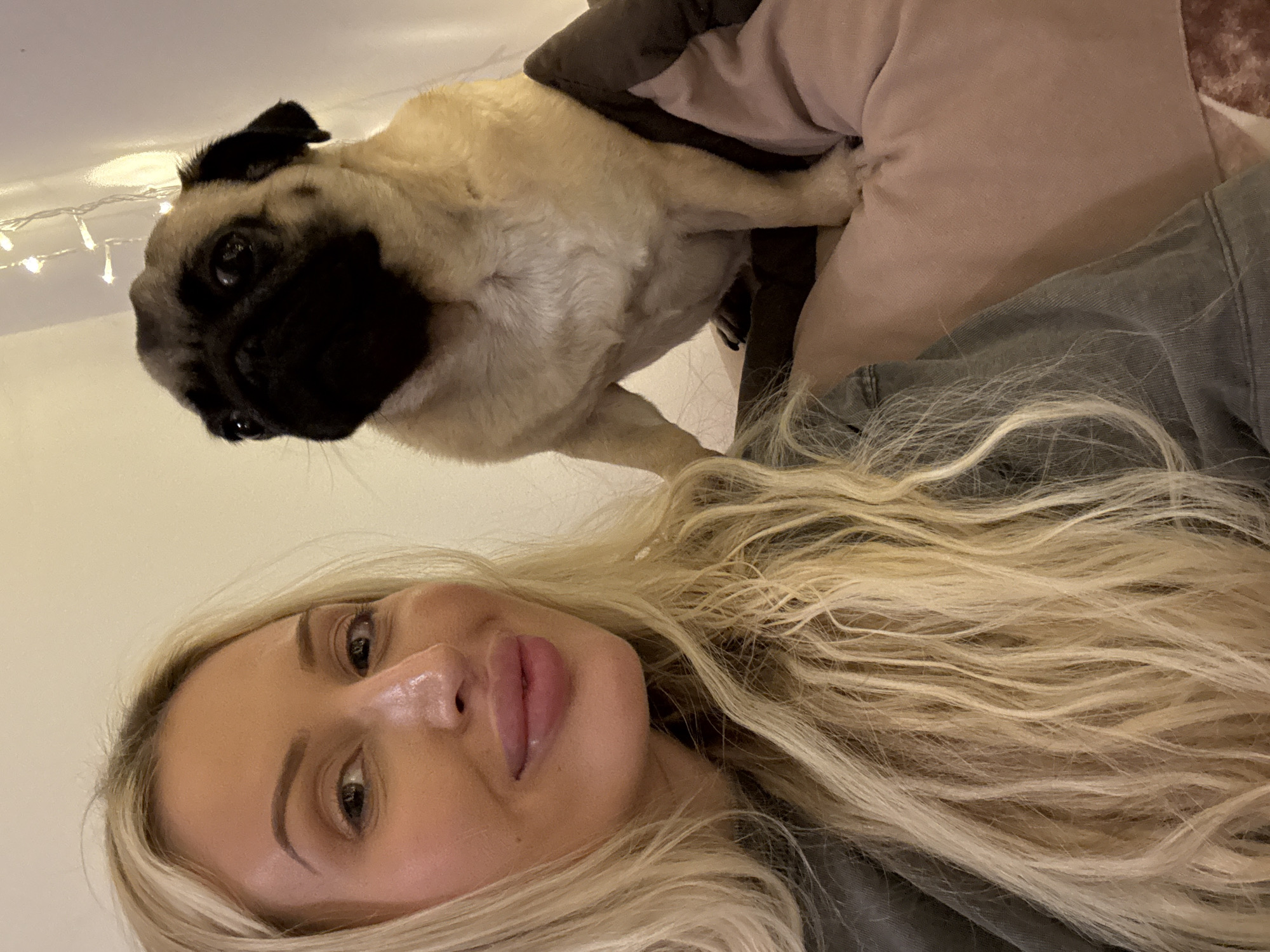 Chill indoor selfie session with a pug and a mocktail