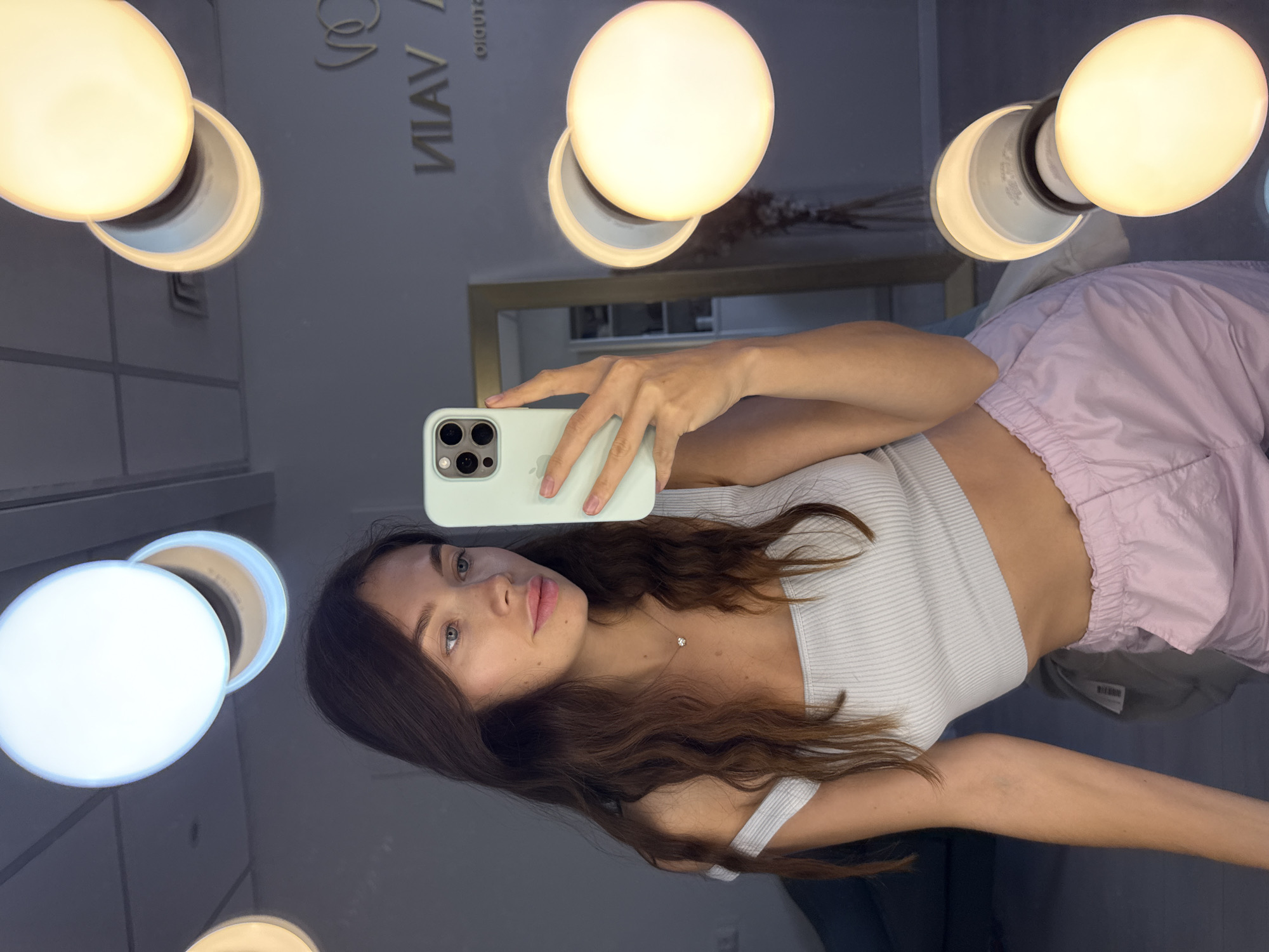 Woman takes selfie at vanity mirror in Ramat Gan