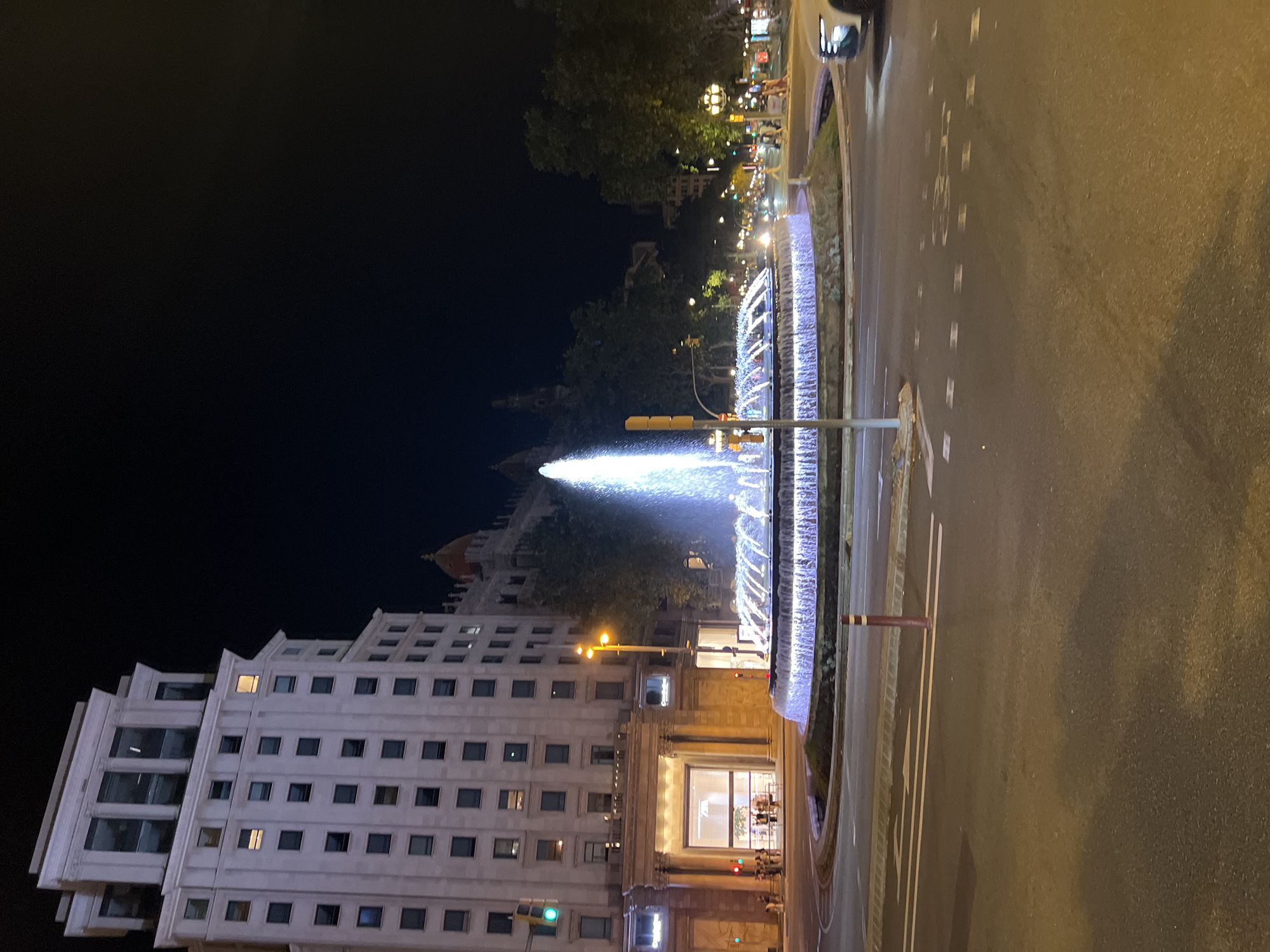 Iconic Barcelona fountain glowing at Passeig de Gràcia by night