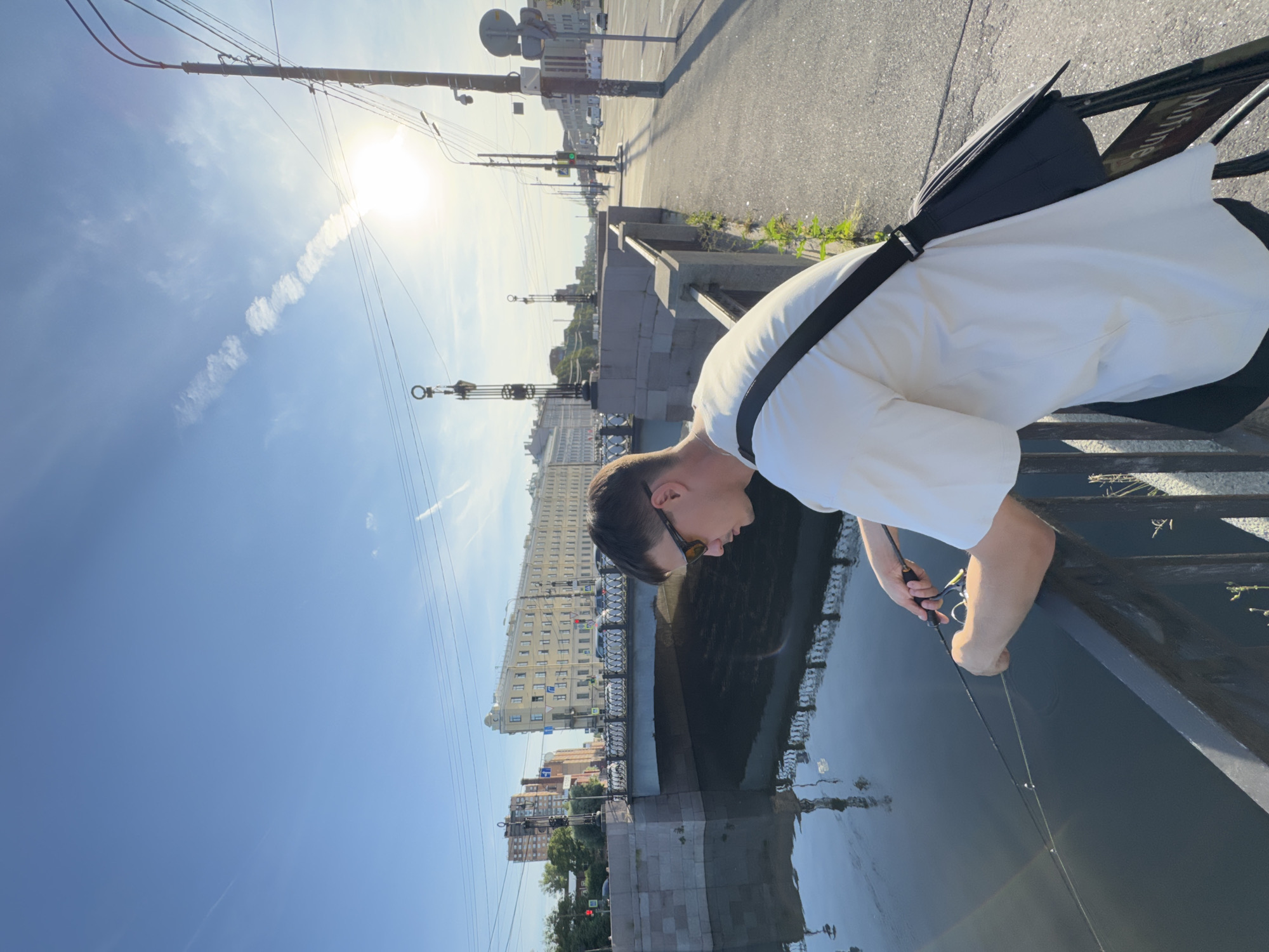 Fishing and hanging out along a Saint Petersburg canal on a sunny day