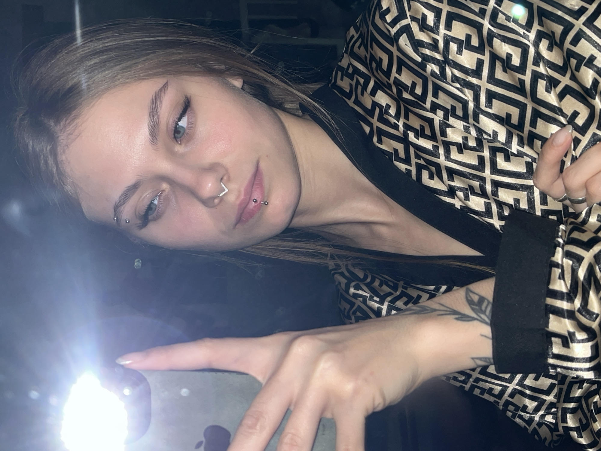 Woman photographed with phone flash in Foki, Russia