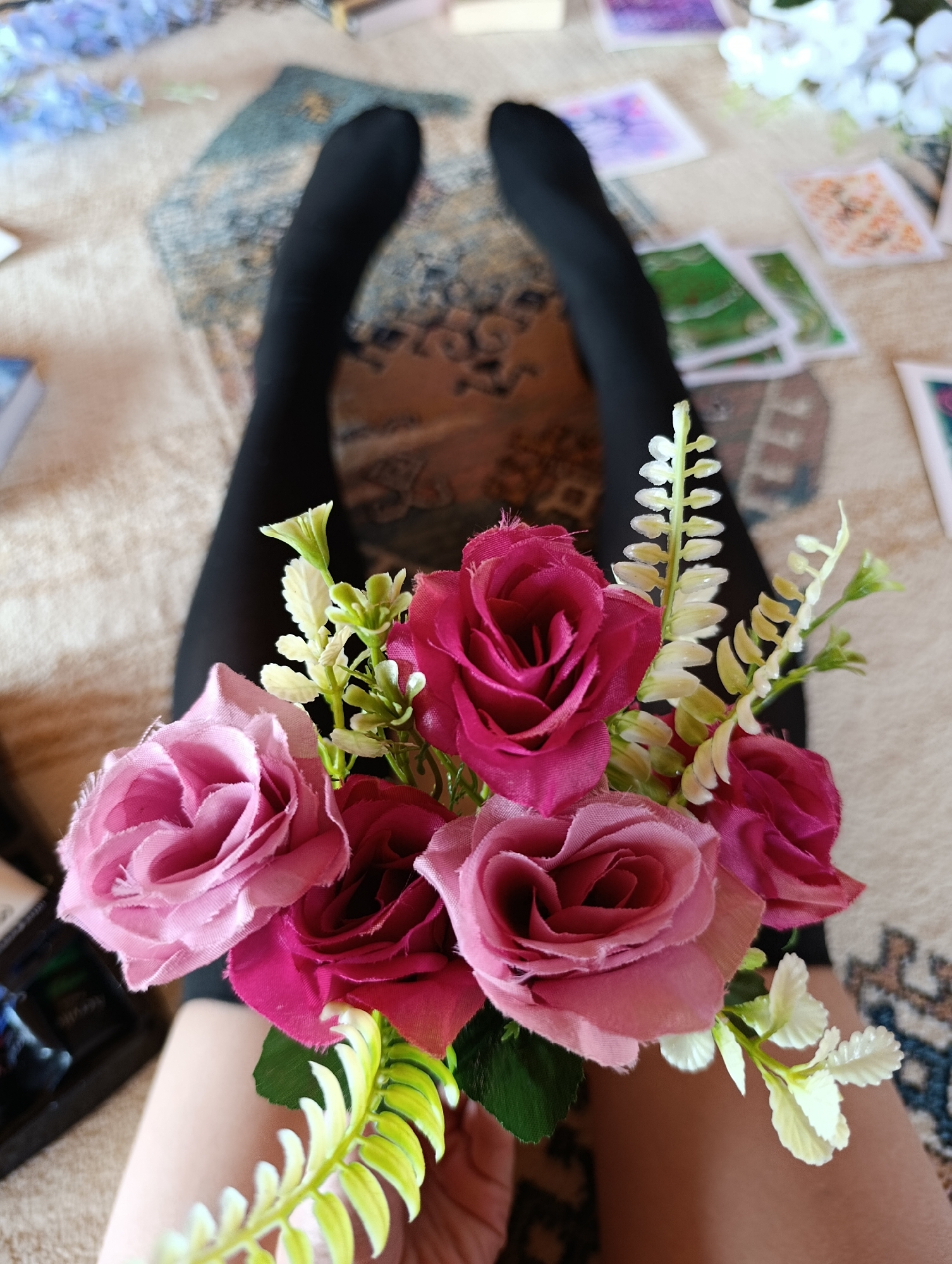 Person holds flower bouquets during intimate indoor session in Bulgaria
