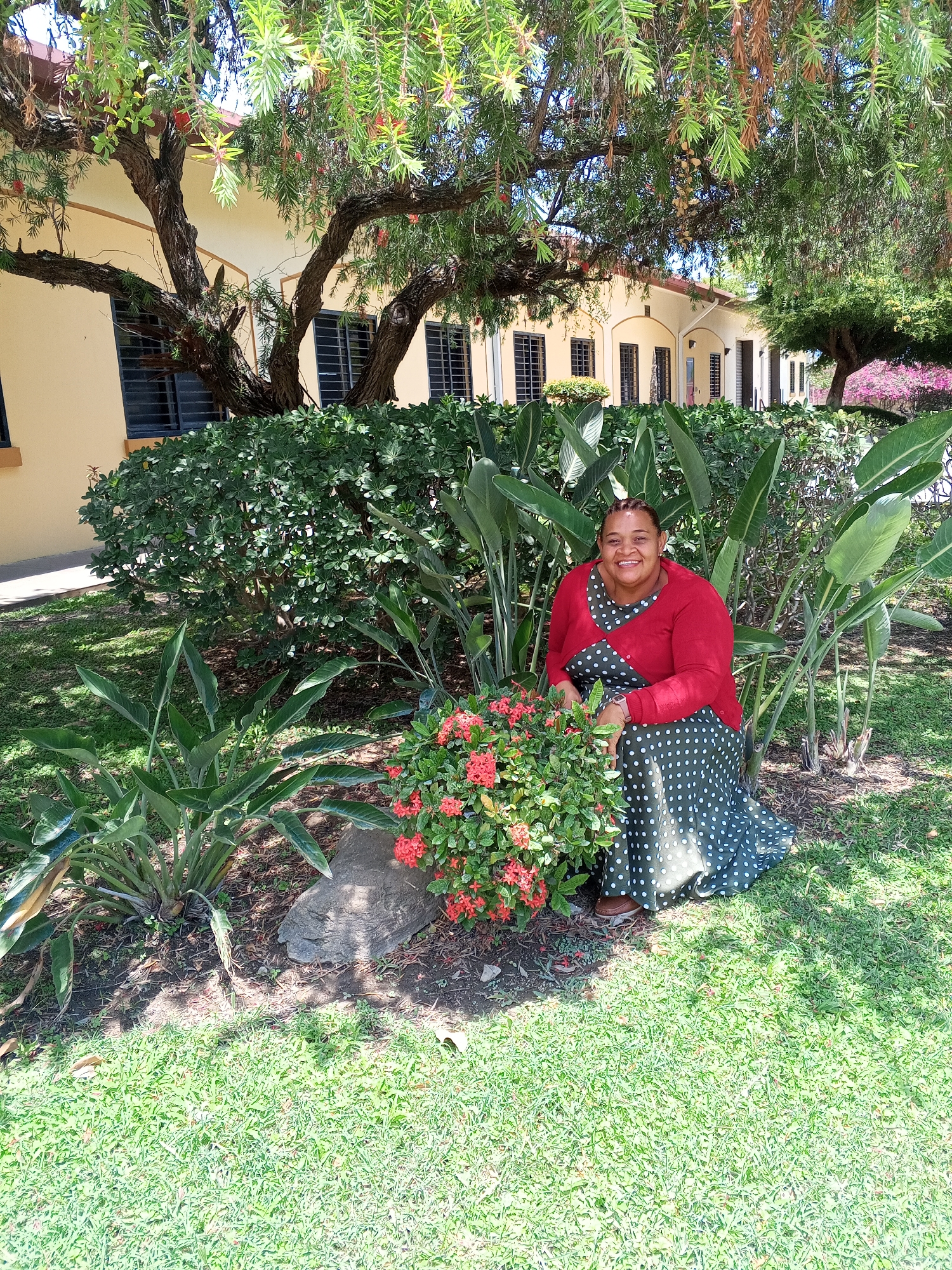 Woman poses in flowering garden in La Victoria