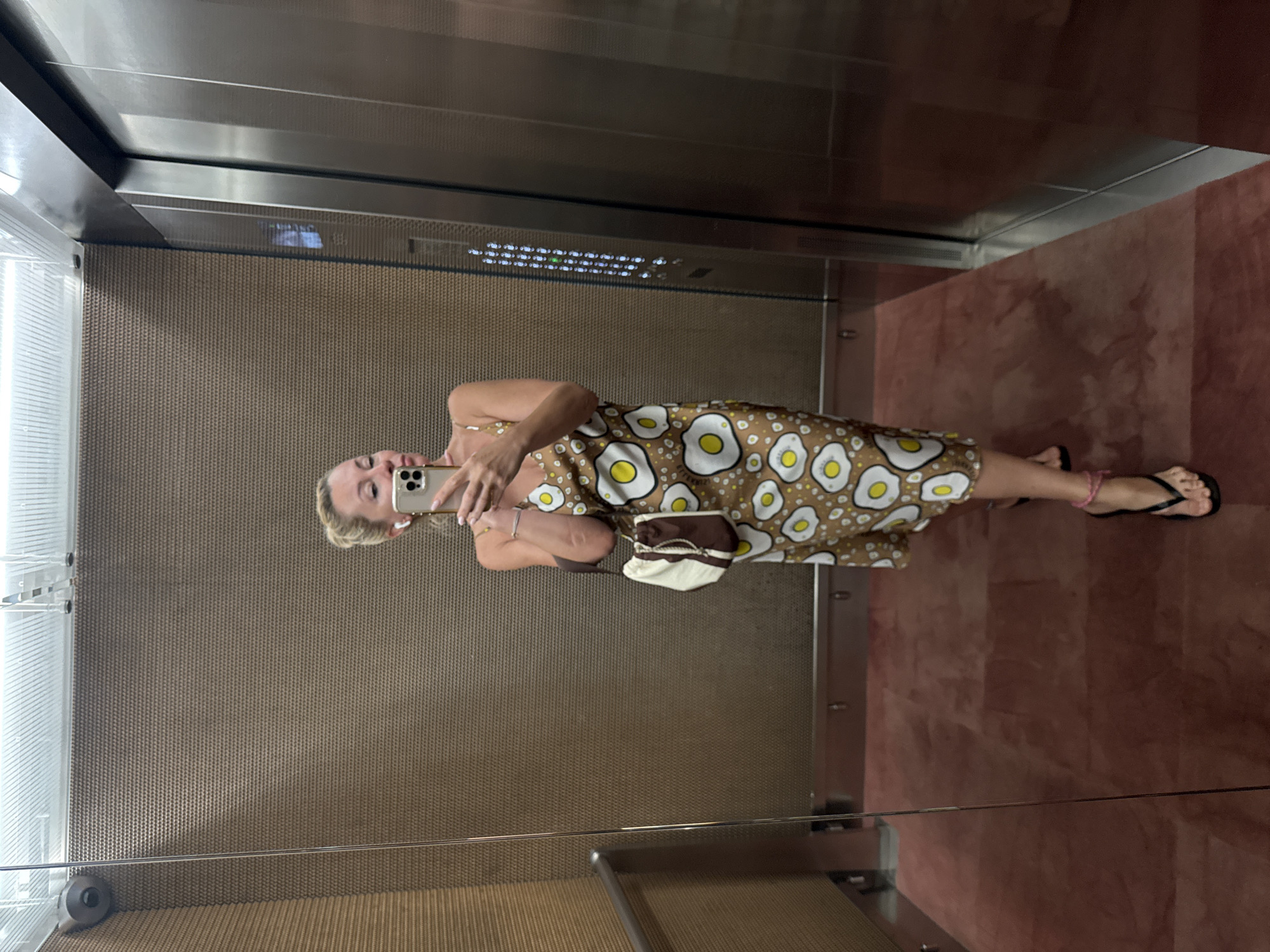 Elevator mirror selfie in a fried egg print dress, Warsaw