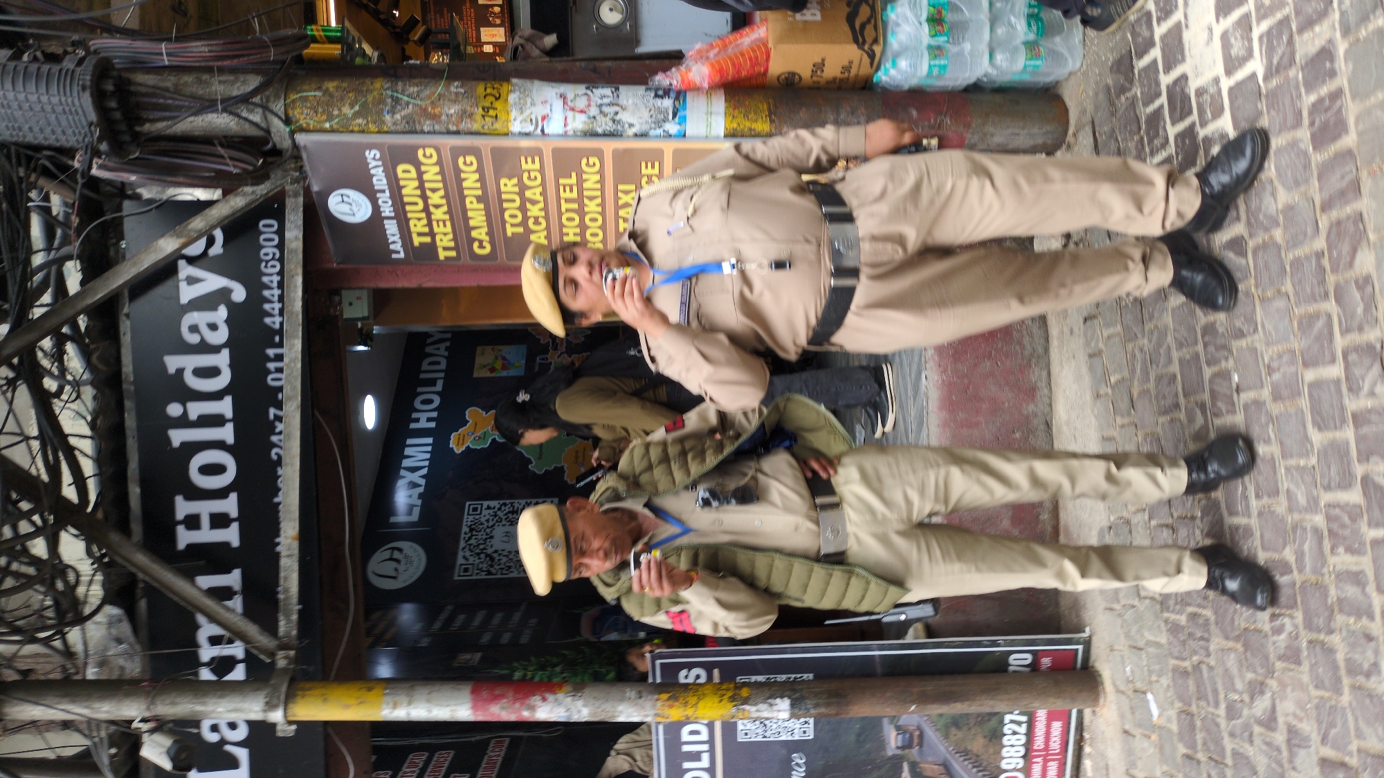 Police officers patrol tourist area in Bhagsu, India