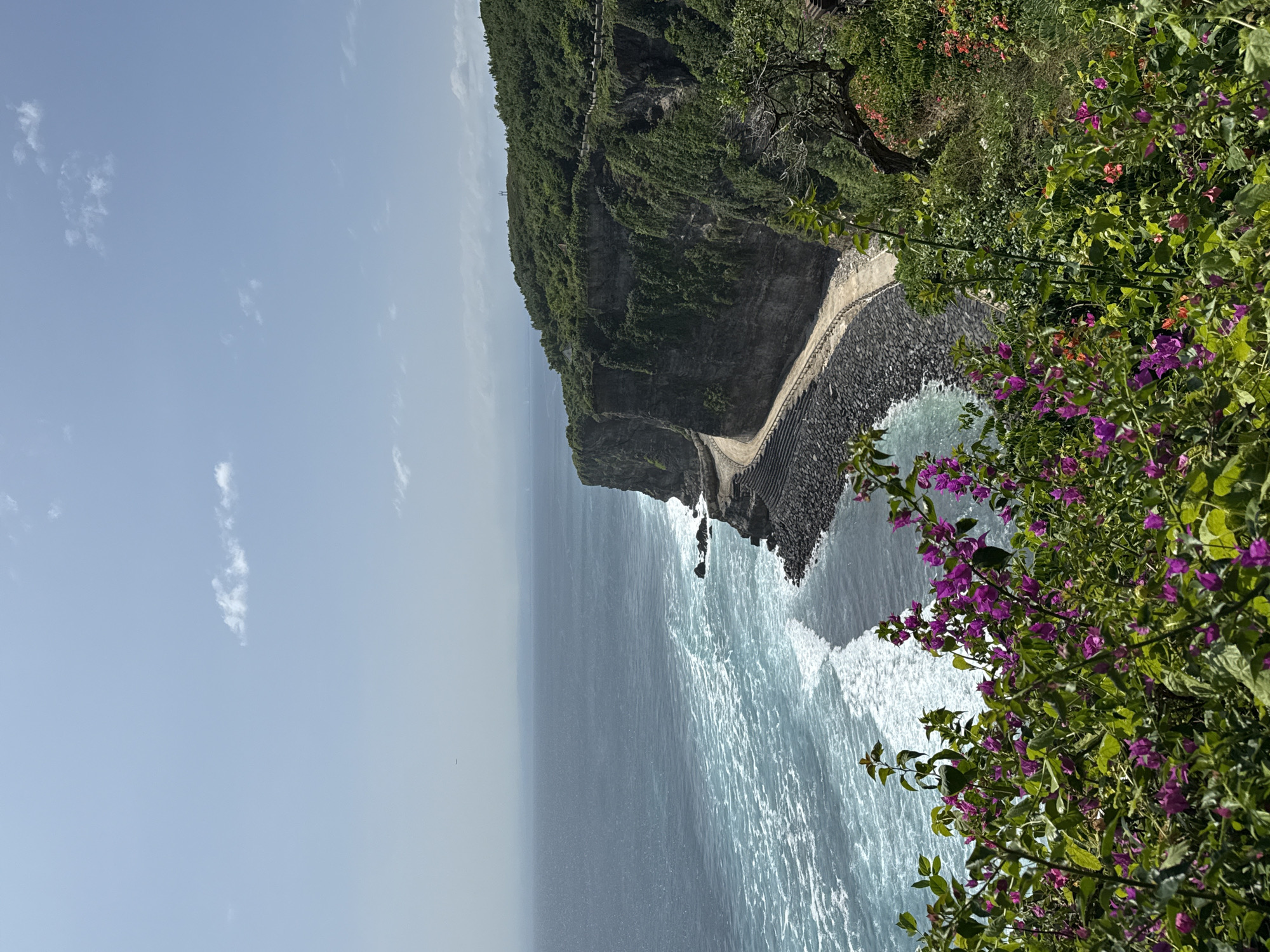 Tourist encounters monkeys at Kuta Selatan clifftop walkways