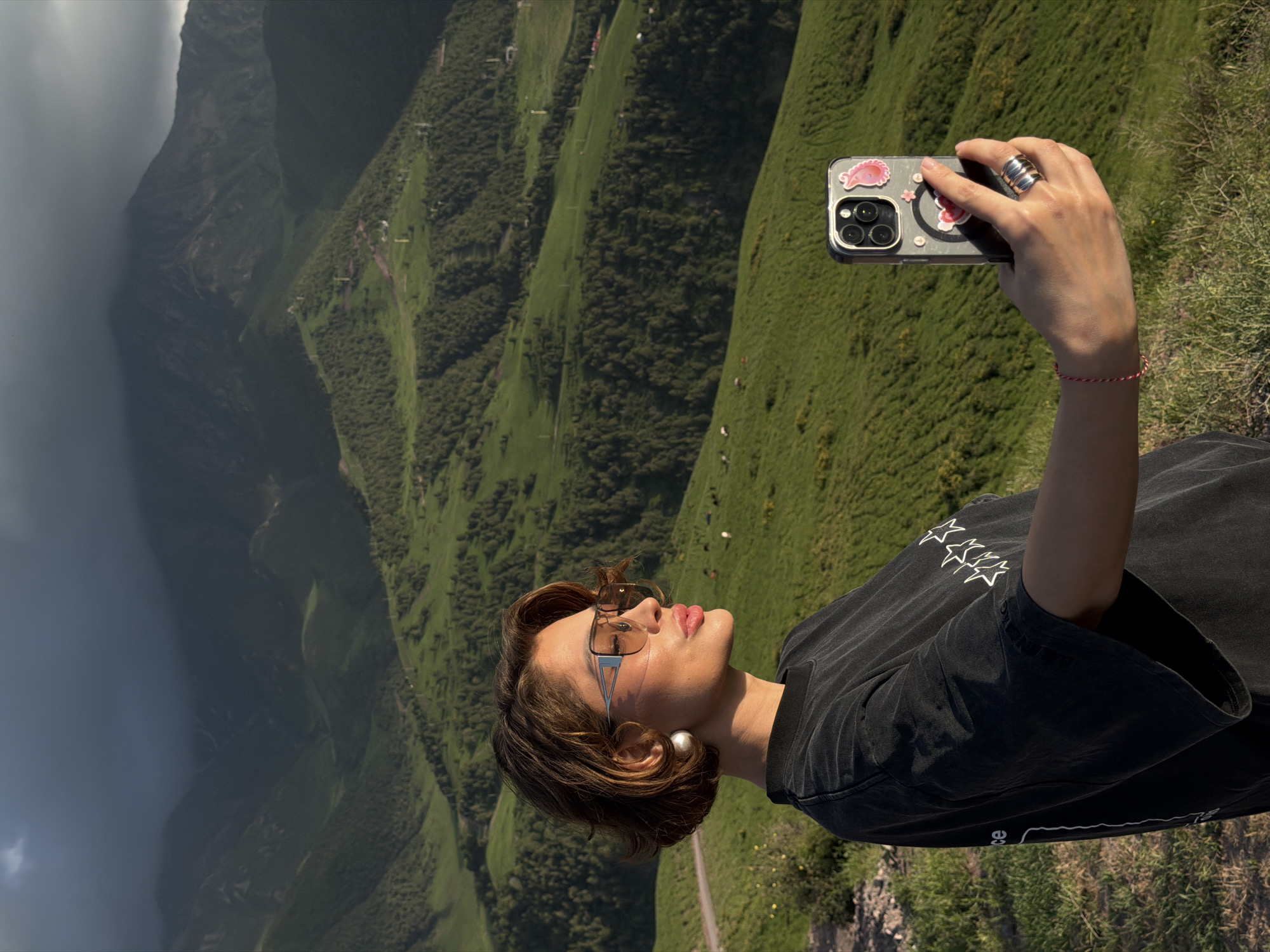 Tourists document verdant mountain scenery in Kashka Suu, Kyrgyzstan