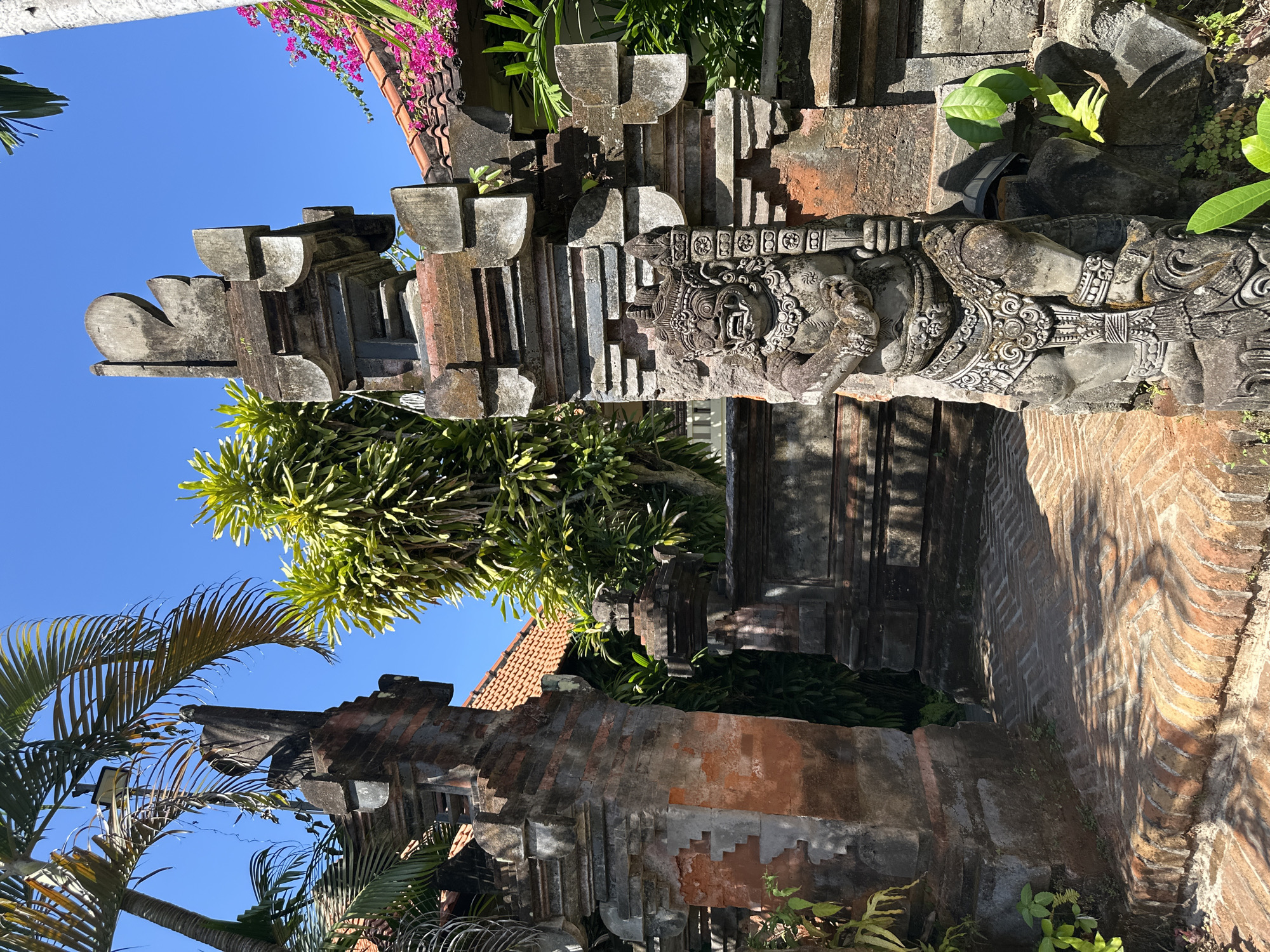 Street scenes and stone carvings across a Denpasar neighborhood
