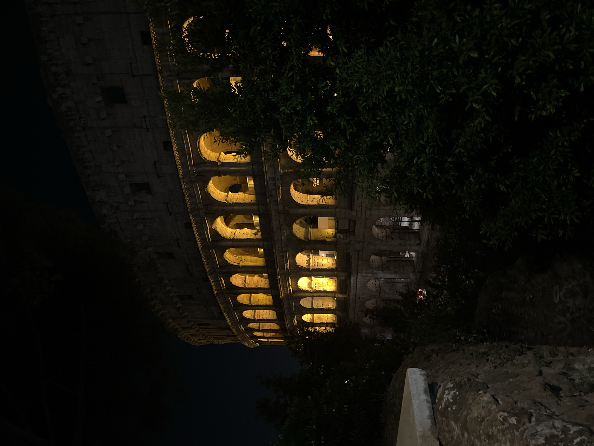 Illuminated Colosseum draws evening visitors in Rome