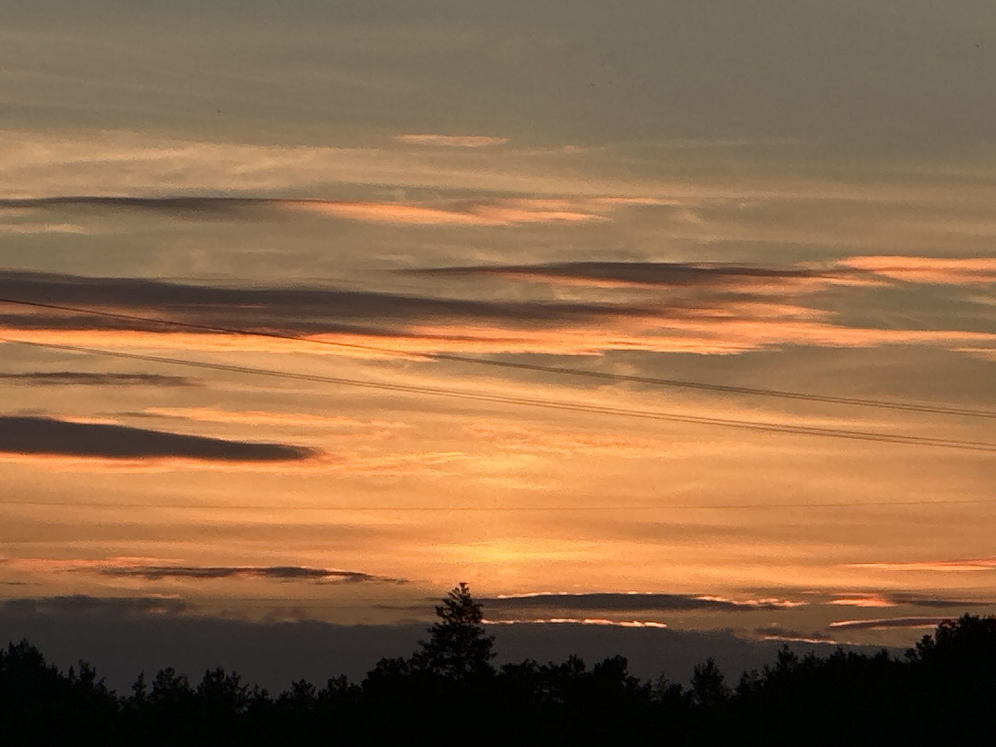 Sunset sky over Yurove, Ukraine, power lines in silhouette