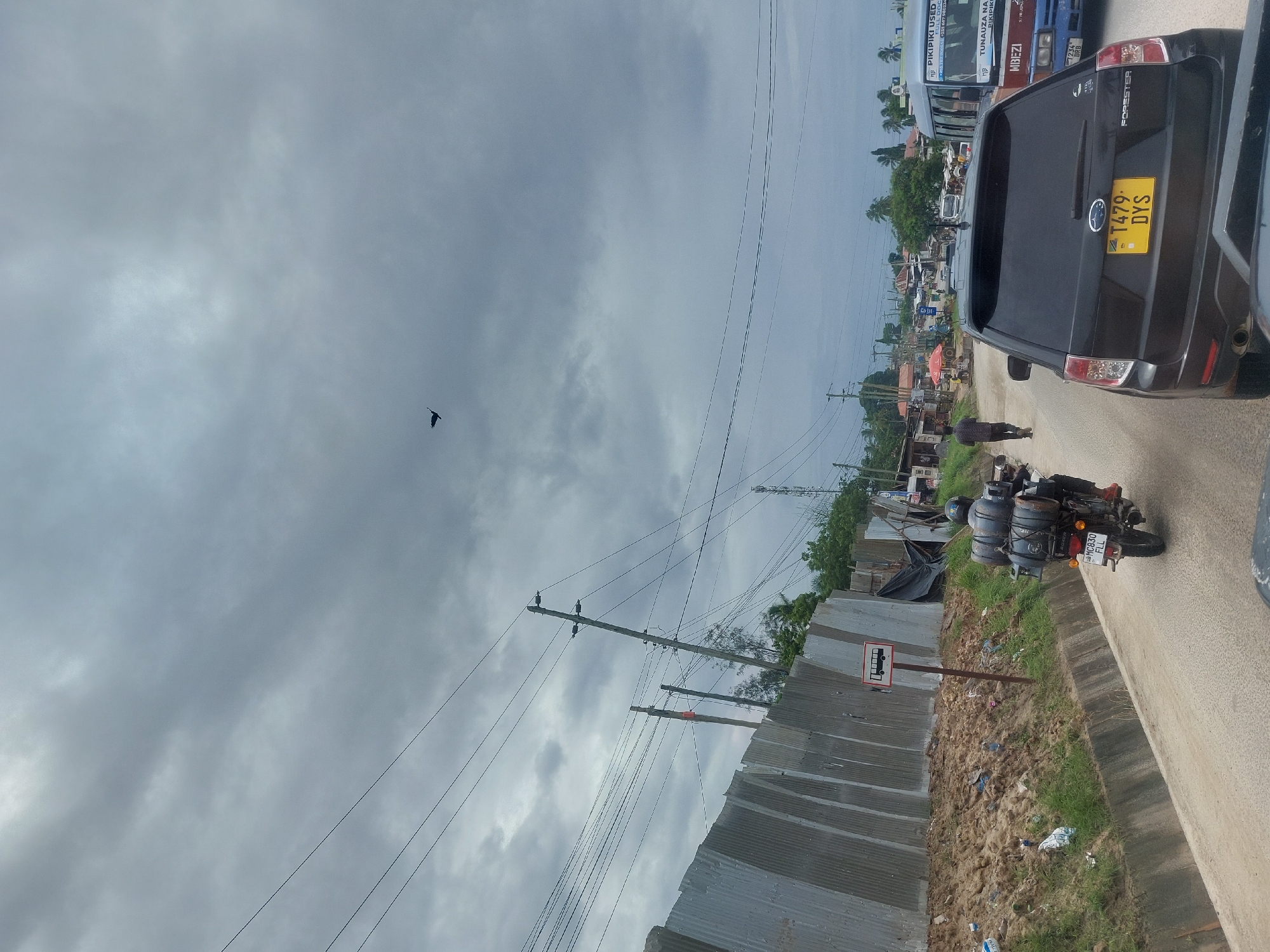 Morning street scenes documented in Dar es-Salaam under overcast skies