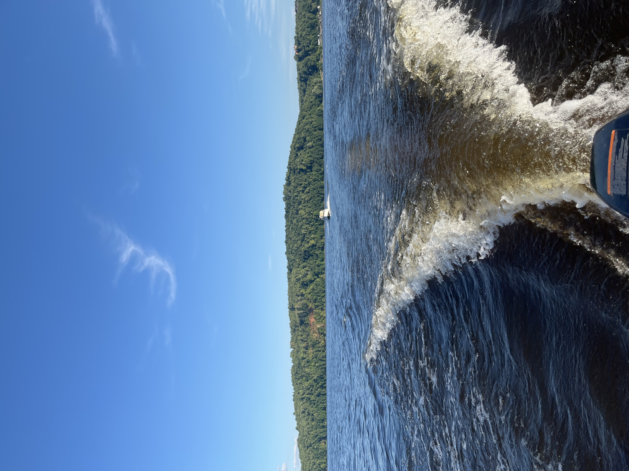 Afternoon on the water near forested shores in rural Russia